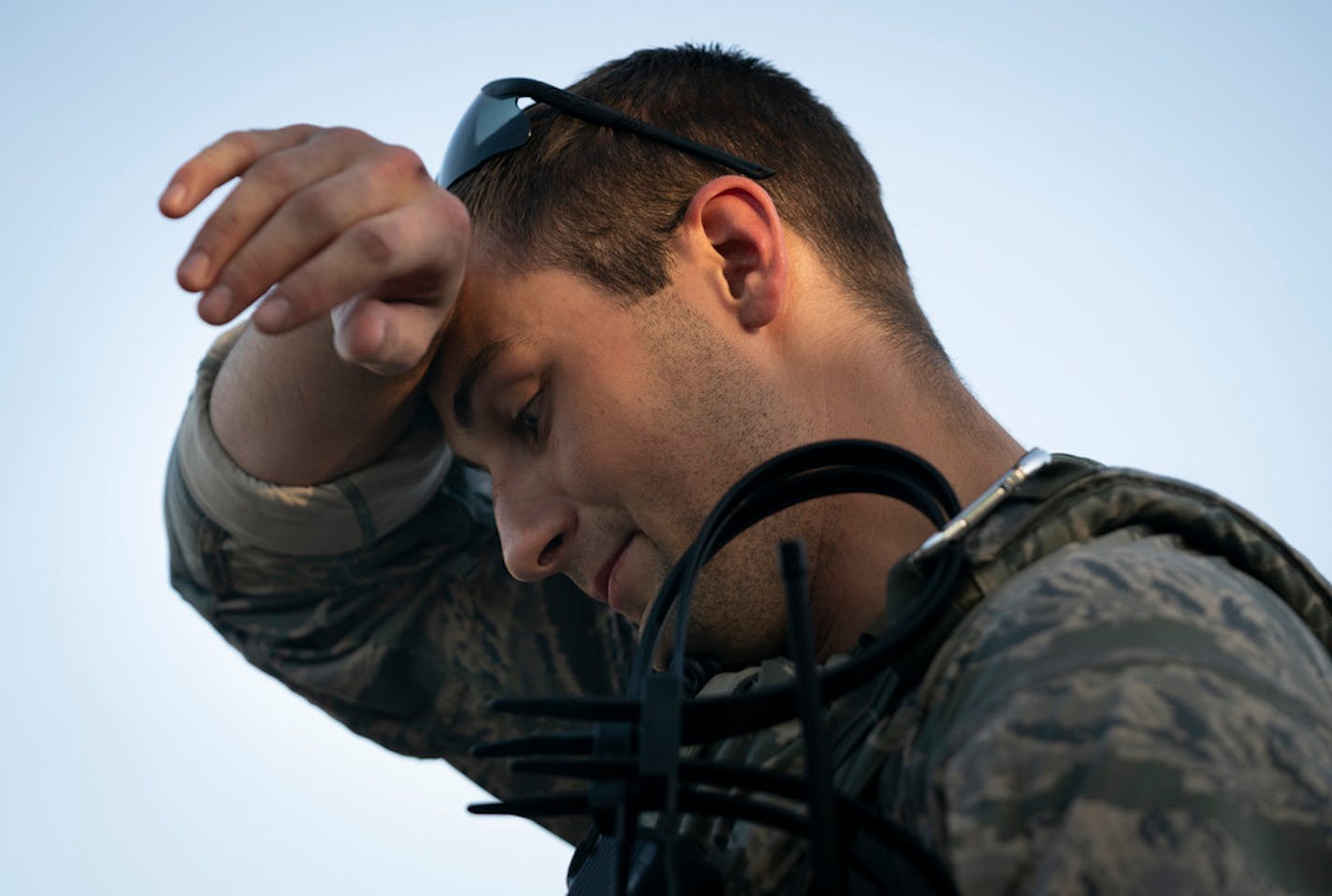 Senior Airman Nathan Van Beusekom wiped his brow in the 90-degree weather as he awaited orders in St. Paul on Monday.