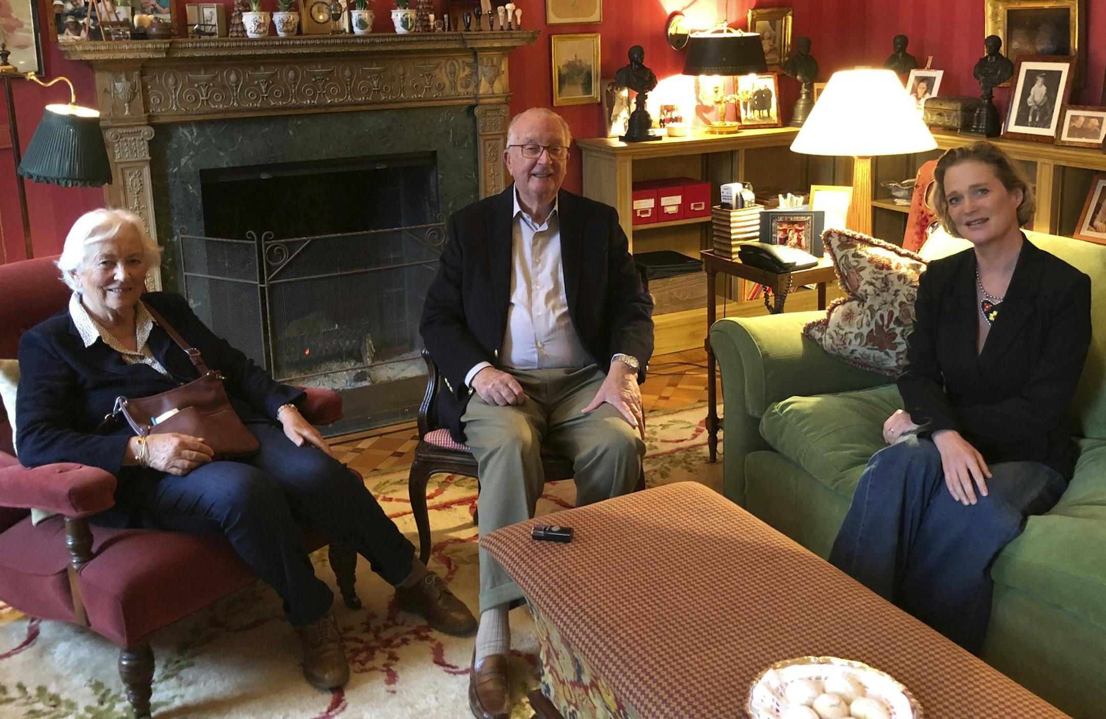 In this handout photo made available by the Belgium Royal palace on Tuesday, Oct. 27, 2020, Delphine Boel, right, now Belgium's Delphine de Saxe-Cobourg Gotha, meets her biological father King Albert II, center, and Queen Paola, left, during an informal meeting in Brussels. Belgium's royal scandal that has riveted the nation and damaged those involved reached a new milestone when former King Albert II reunited with the daughter he fathered out of wedlock over half a century ago. Capping a moment