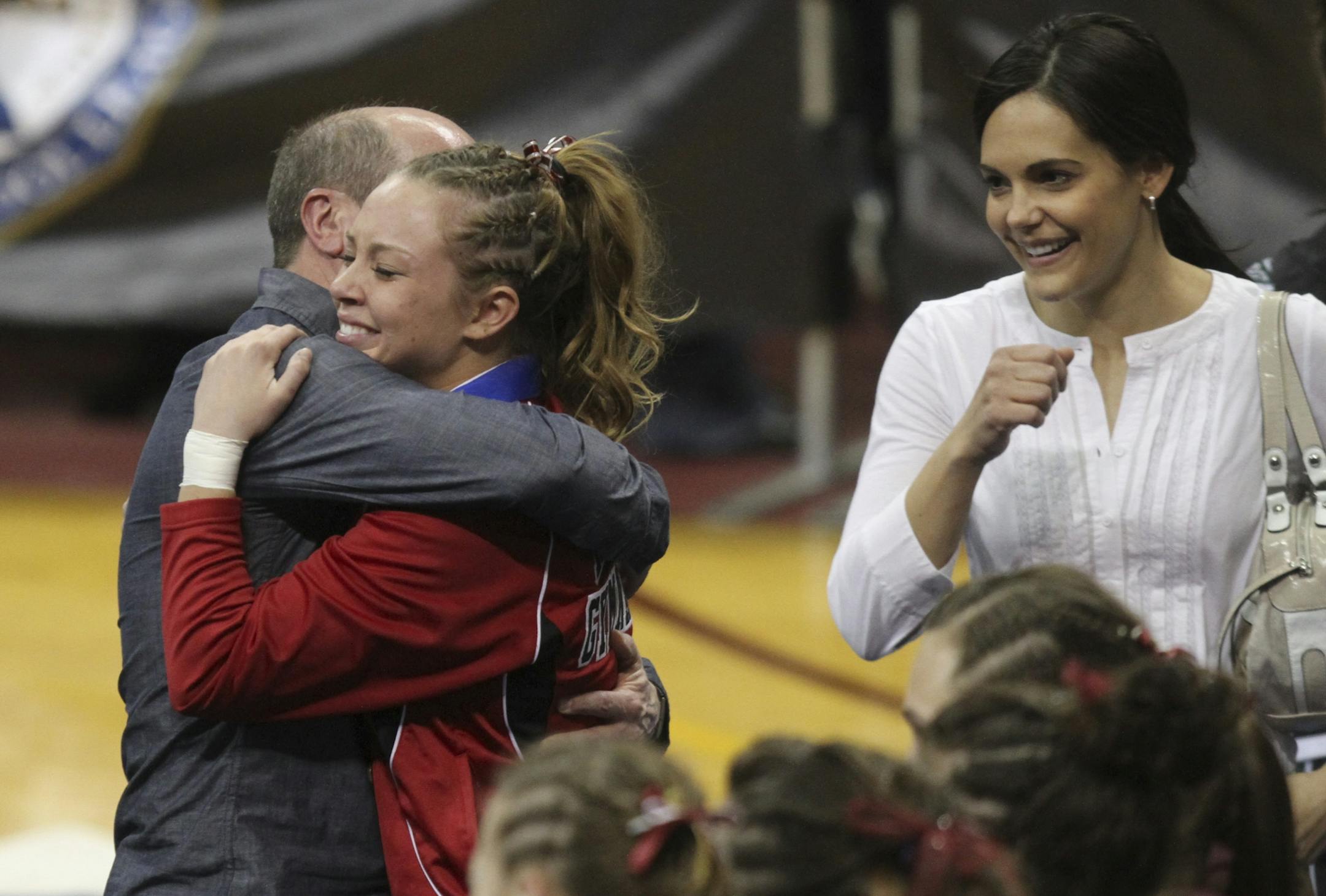Julia Stedman, North St. Paul, received a hug from her coach Lenny Crouse after she won the all around champion in the Class AA individual girls all-around gymnastics championship at the Sports Pavilion in Minneapolis Min., Saturday, February 25, 2012.
