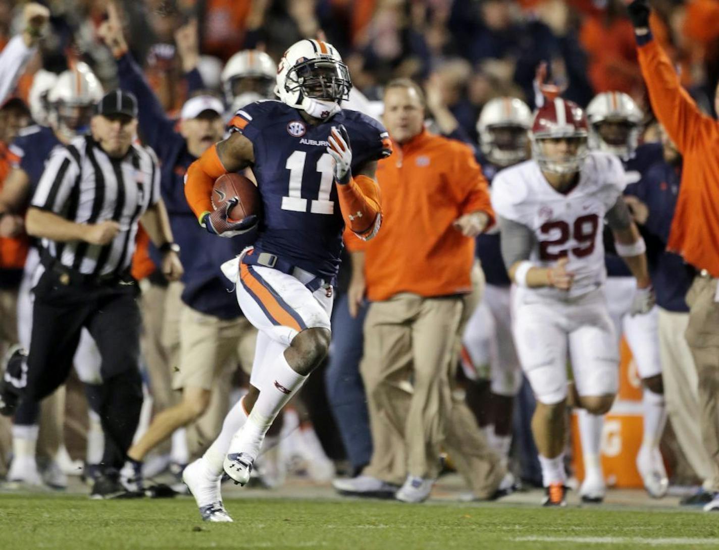 Auburn cornerback Chris Davis (11) returns a missed field goal attempt 100-plus yards to score the game-winning touchdown as time expired in the fourth quarter of an NCAA college football game against No. 1 Alabama in Auburn, Ala., Saturday, Nov. 30, 2013. Auburn won 34-28.