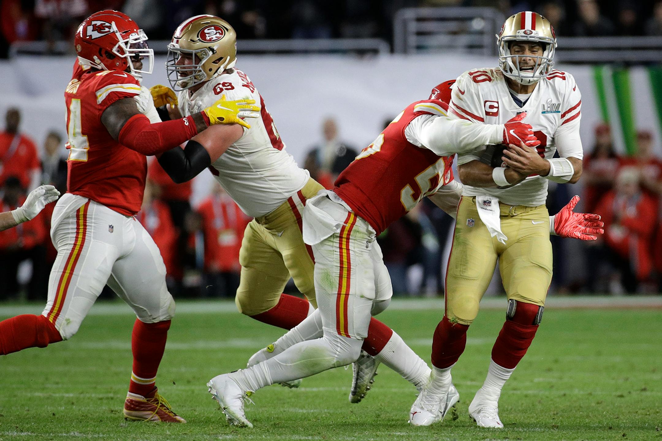 Kansas City Chiefs' Frank Clark, left, sacks San Francisco 49ers quarterback Jimmy Garoppolo during the second half of the NFL Super Bowl 54 football game Sunday, Feb. 2, 2020, in Miami Gardens, Fla.