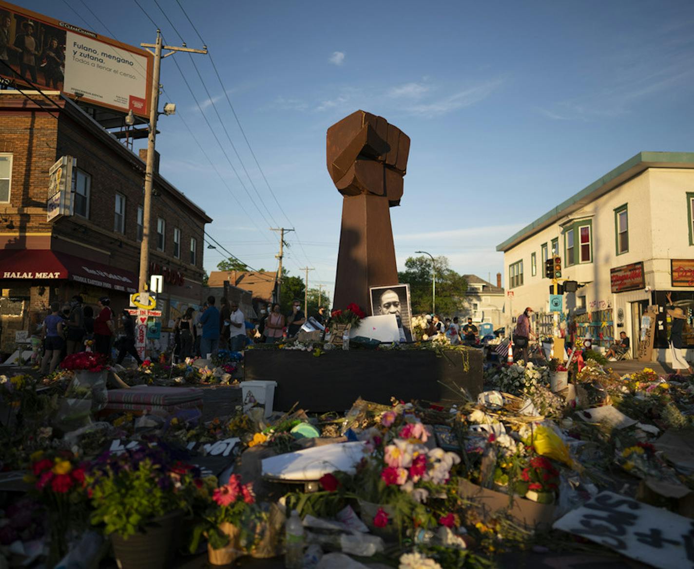 The new fist sculpture was moved to the center of the intersection Sunday evening. ] JEFF WHEELER • Jeff.Wheeler@startribune.com The intersection of E. 38th St. and Chicago Ave. S. in Minneapolis continues to attract visitors seeking to bear witness following the killing of George Floyd. At dusk Sunday evening, June 7, 2020 hundreds gathered at the memorial with tombstones to honor the dead and hear their names read.