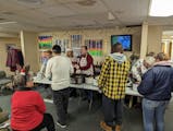 A board member for the Nameless Coalition for the Homeless in Bemidji and other volunteers serve a Christmas meal to clients earlier this month.