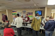 A board member for the Nameless Coalition for the Homeless in Bemidji and other volunteers serve a Christmas meal to clients earlier this month.