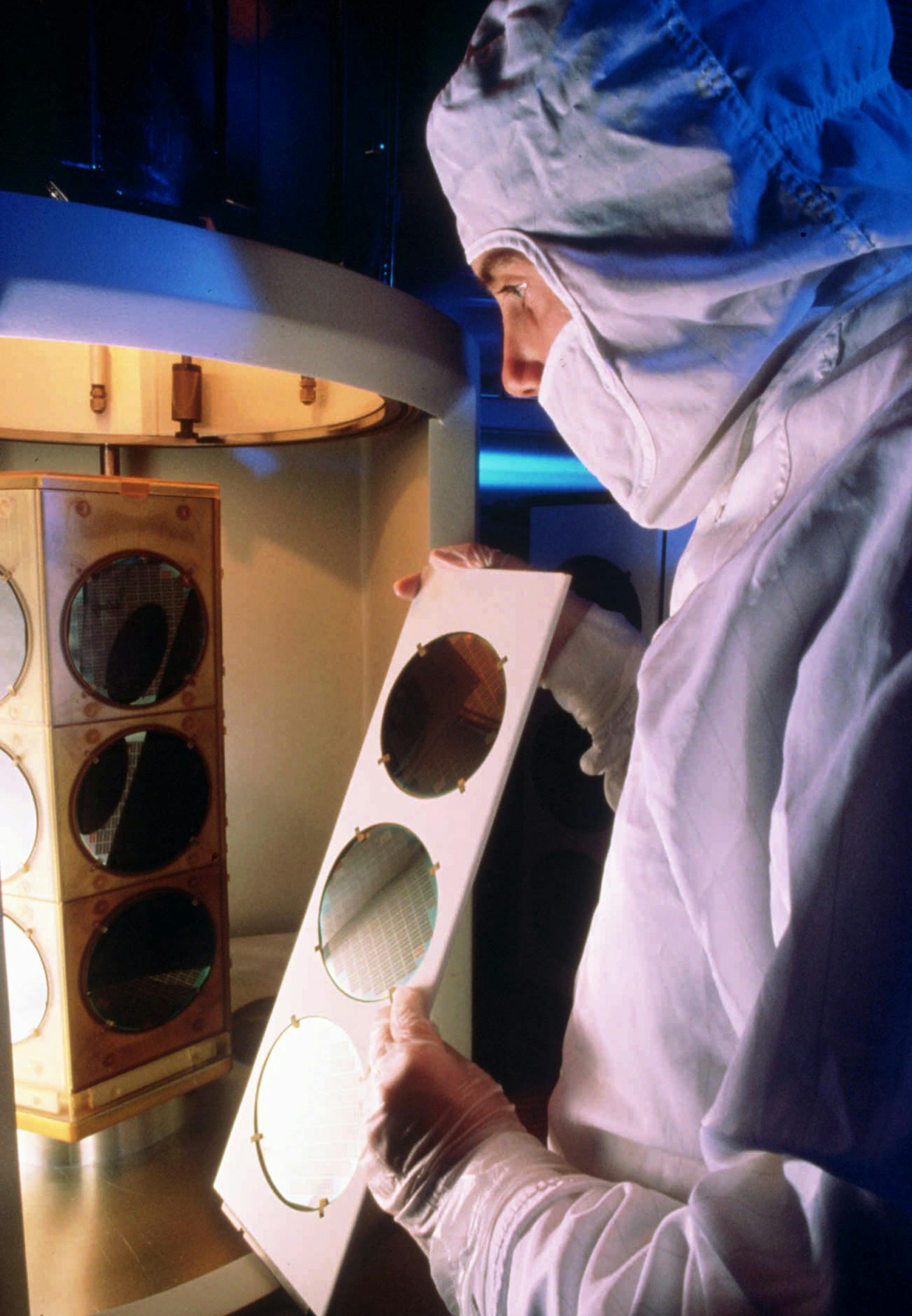 FILE-In this undated file photo, an unidentified worker at the IBM plant in Essex Junction, Vt., works on manufacturing microchips. Gov. Peter Shumlin says IBM has notified him that a nationwide reorganization will mean job losses in Vermont. IBM currently employs slightly more than 4,000 people at its plants in Chittenden County. Vermont Labor Commissioner Annie Noonan says her department is ready to work with laid off IBM employees to ensure they can get unemployment benefits and to help them
