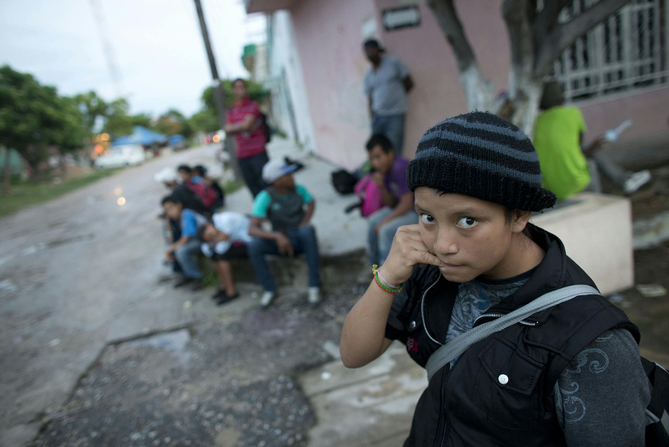 In this June 19, 2014 photo, a 14-year-old Guatemalan girl traveling alone waits for a northbound freight train along with other Central American migrants, in Arriaga, Chiapas state, Mexico. The United States has seen a dramatic increase in the number of Central American migrants crossing into its territory, particularly children traveling without any adult guardian. More than 52,000 unaccompanied children have been apprehended since October. (AP Photo/Rebecca Blackwell) ORG XMIT: MIN20140710172