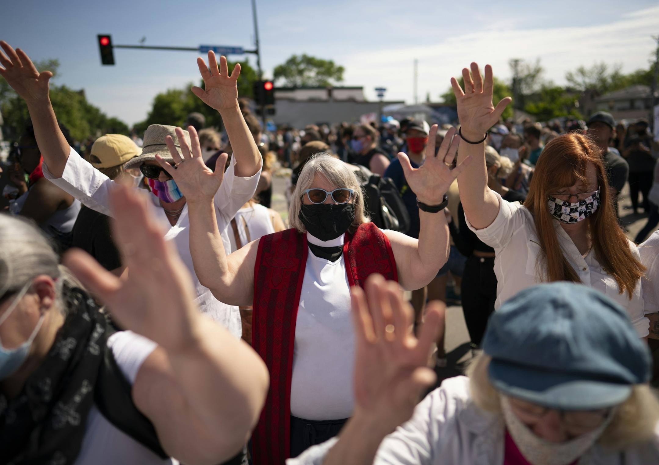 A group of faith leaders, including Rev. Karen Chatfield Bruins of Lake Harriet United Methodist Church, center, prayed silently near the intersection where George Floyd was killed. One their number, Fr. Paul Jarvis said "We're using silence because how could words ever express the incredible and unprecedented horror that everyone is experiencing right now."