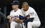 Minnesota Twins' Eduardo Escobar, waits to bat, next to manager Paul Molitor during the ninth inning of the second game of a doubleheader Aug. 11