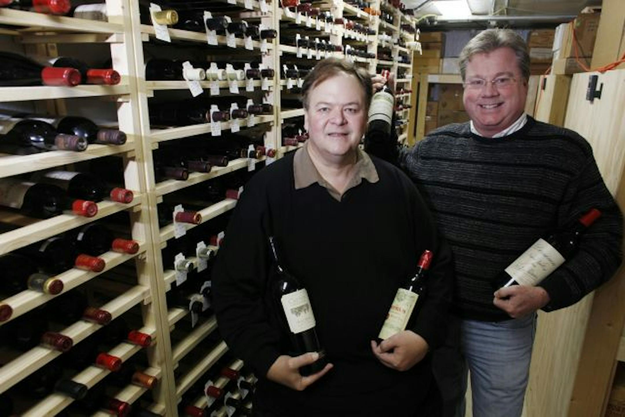 Mike Wigley, left, and Brain Jackson in their wine cellar.