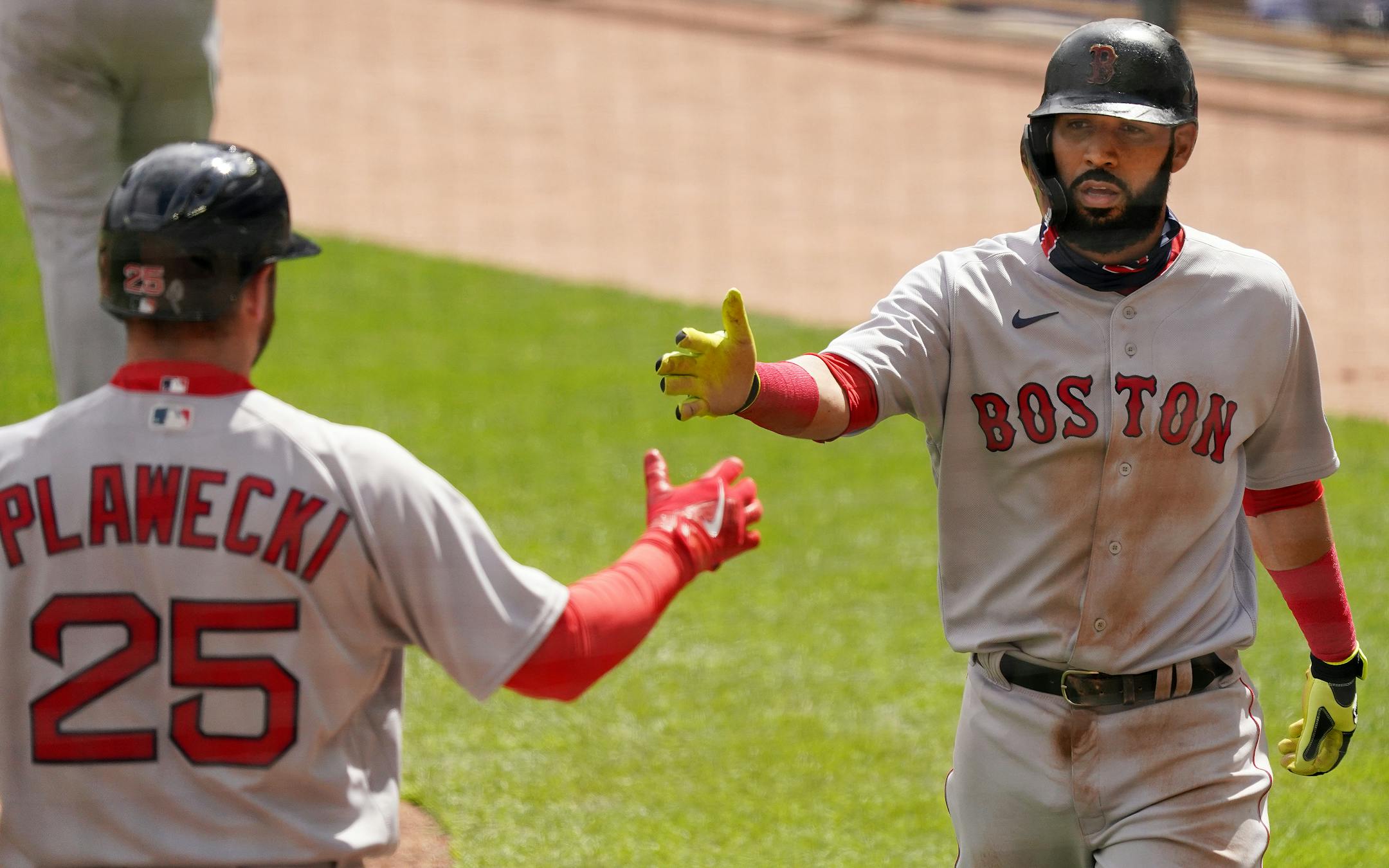 Boston Red Sox third baseman Marwin Gonzalez (12) celebrated with Boston Red Sox catcher Kevin Plawecki (25) after scoring in the second inning.