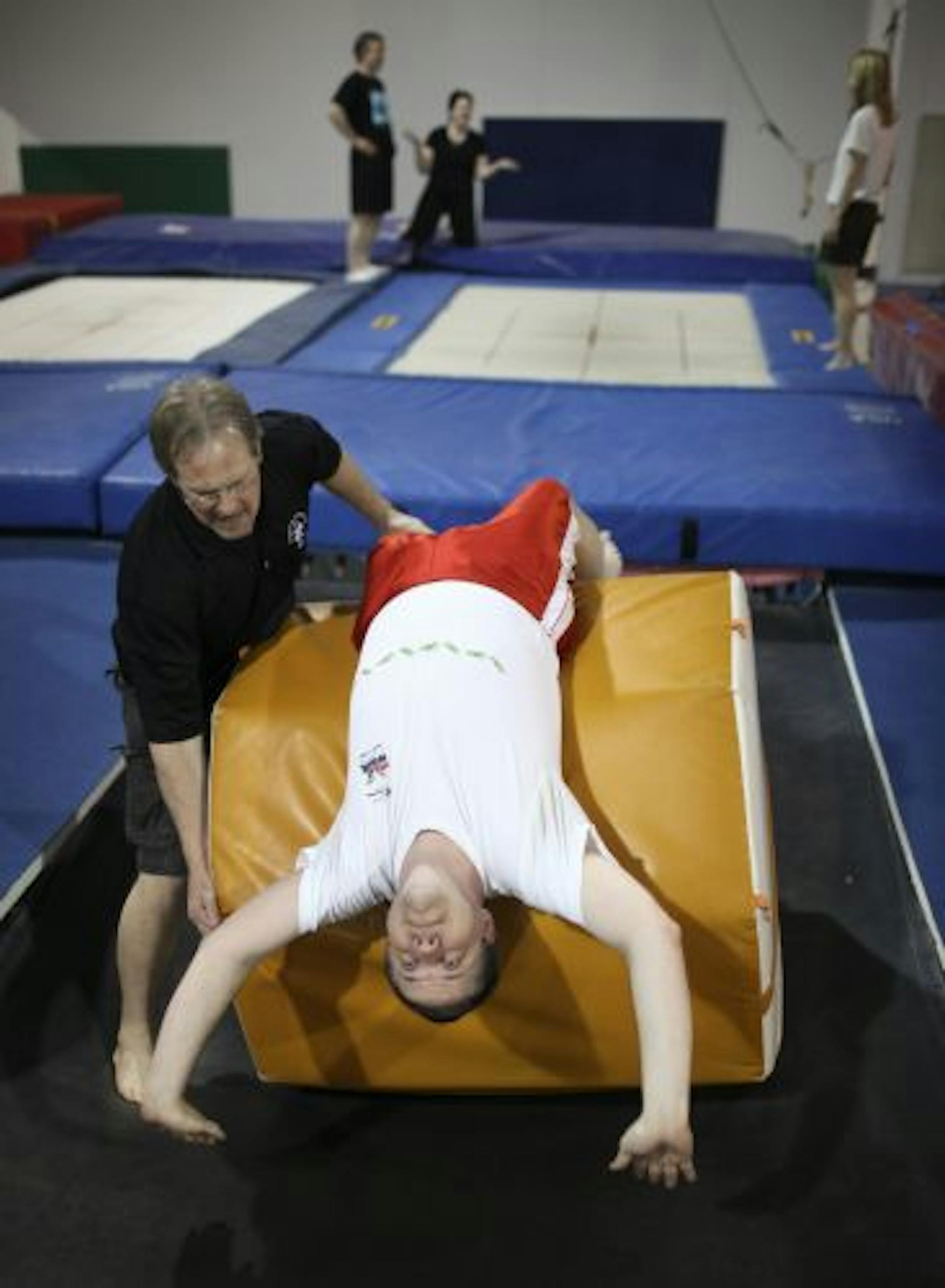 Dave Kennedy worked with Steve Vetter, 52, who was learning how to perform a back flip on the trampoline.