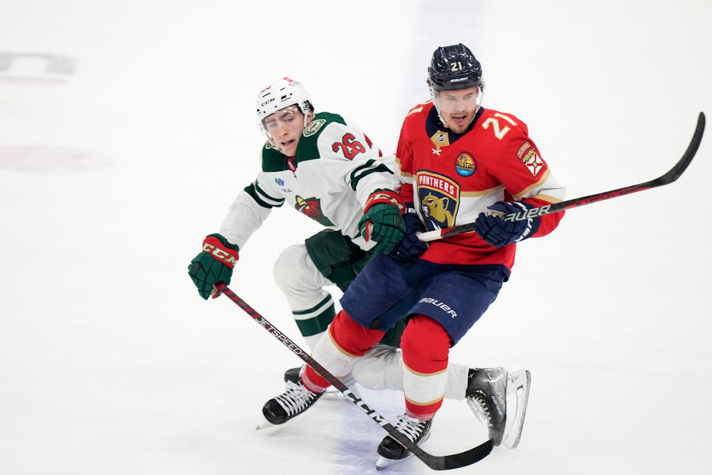 Minnesota Wild center Connor Dewar (26) and Florida Panthers center Nick Cousins (21) battle for position during the third period of an NHL hockey game, Saturday, Jan. 21, 2023, in Sunrise, Fla. (AP Photo/Wilfredo Lee)