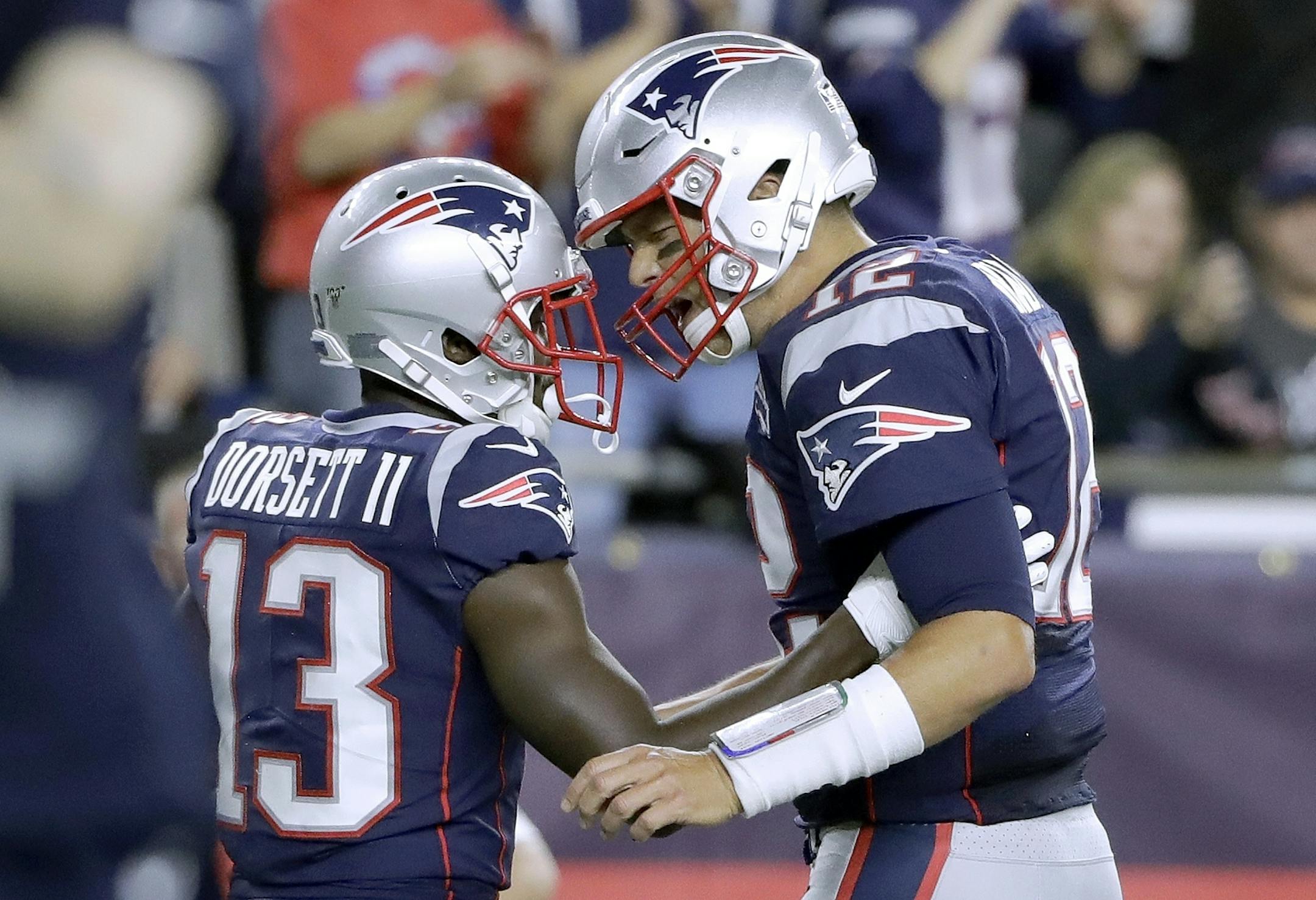 New England Patriots quarterback Tom Brady, right, celebrates his touchdown pass to Phillip Dorsett, left, in the first half an NFL football game against the Pittsburgh Steelers, Sunday, Sept. 8, 2019, in Foxborough, Mass. (AP Photo/Steven Senne)