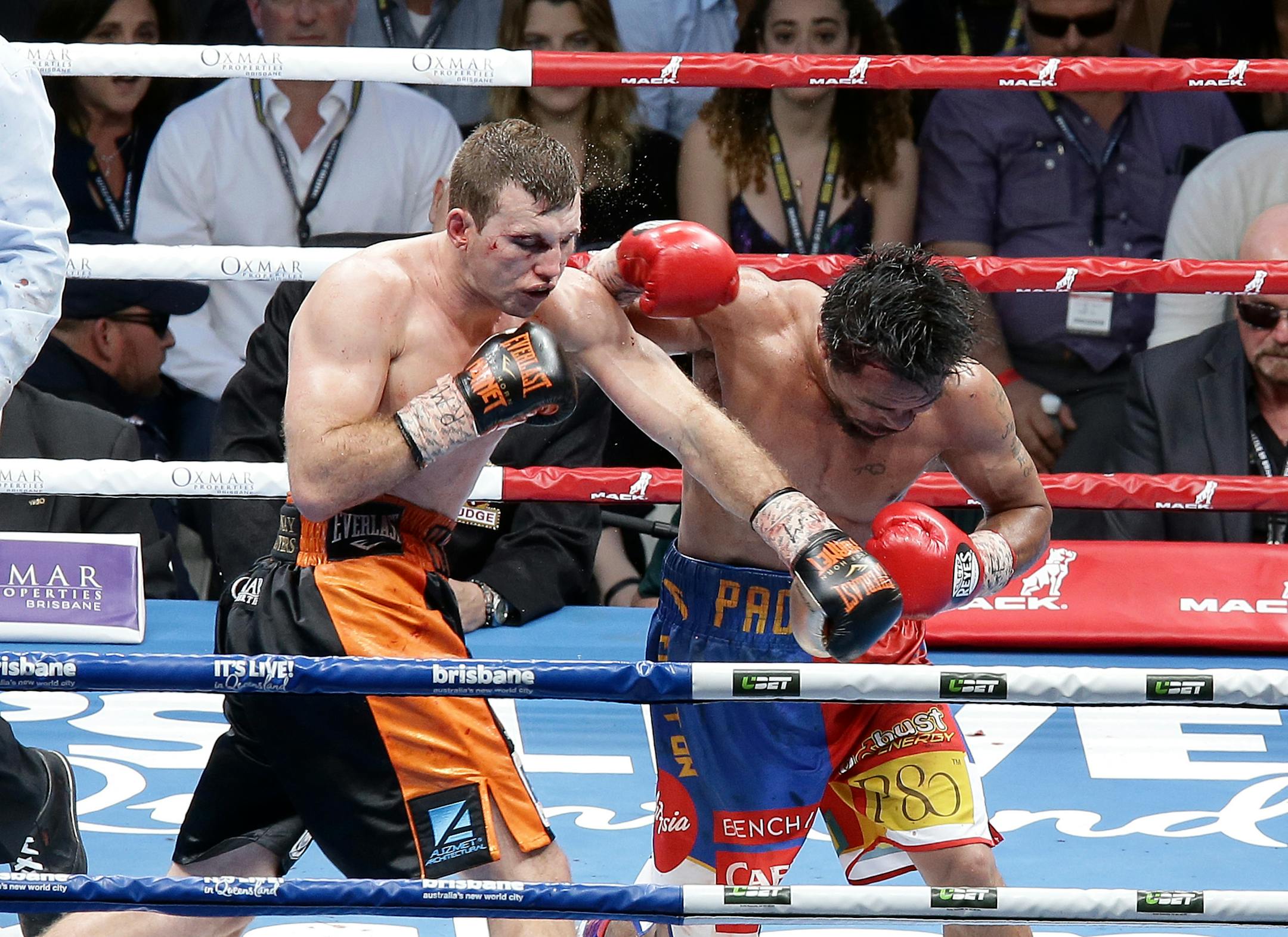 Jeff Horn of Australia, left, and Manny Pacquiao of the Philippines, right, lands a left to during their WBO World Welterweight title fight in Brisbane, Australia, Sunday, July 2, 2017. Pacquiao lost his WBO welterweight world title to Horn in a stunning, unanimous points decision in a Sunday afternoon bout billed as the Battle of Brisbane in front of more than 50,000 people.(AP Photo/Tertius Pickard)