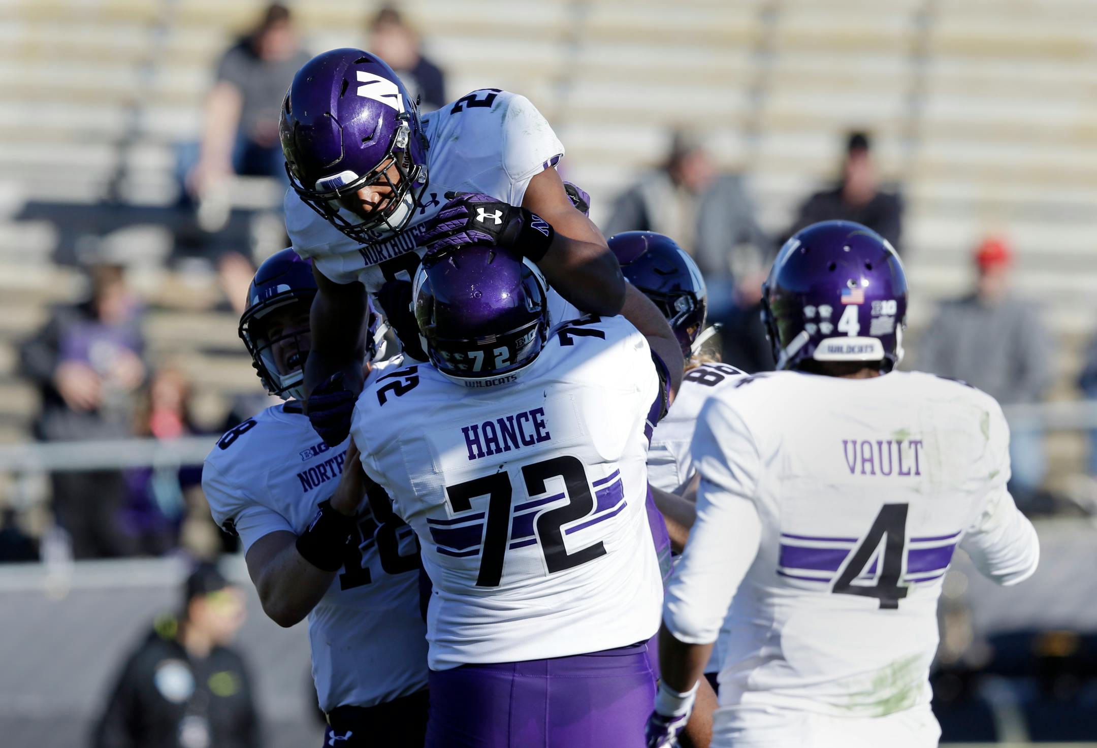 Northwestern running back Justin Jackson (21) celebrated a touchdown with teammates quarterback Clayton Thorson (18) left, and offensive lineman Blake Hance (72) during the second half of an NCAA college football game against Purdue in West Lafayette, Ind., Saturday, Nov. 12, 2016.