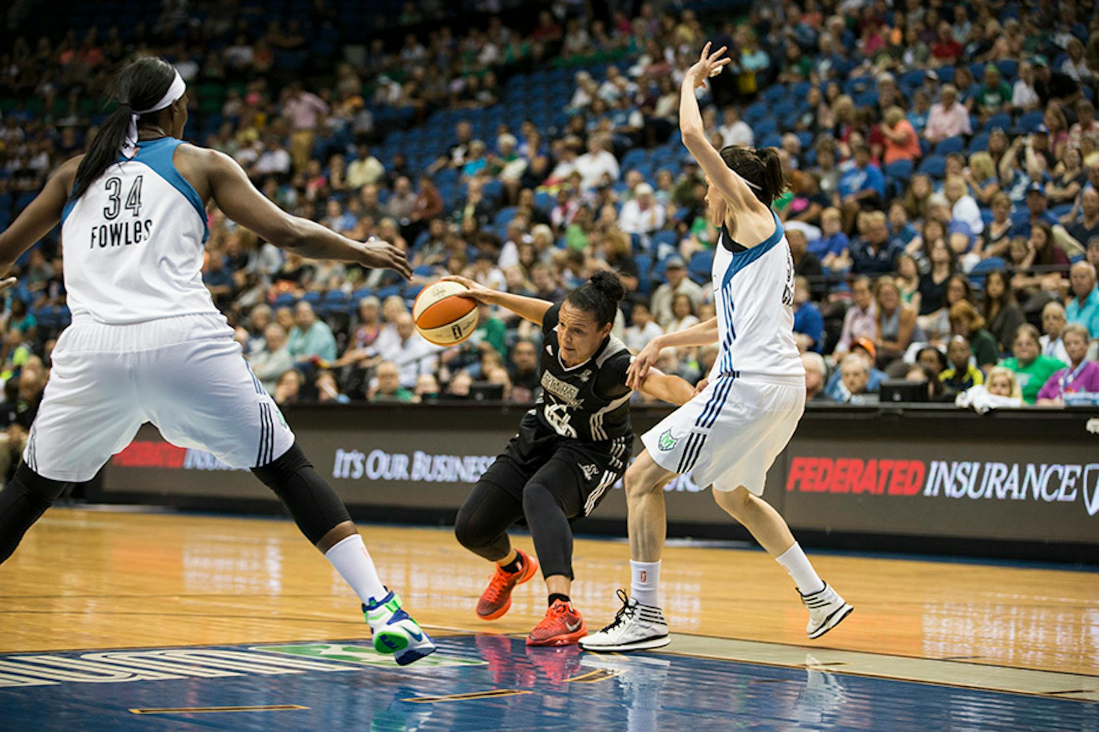 Lynx players Sylvia Fowles and Anna Cruz tried to stop San Antonio's Kayla McBride in the first half.