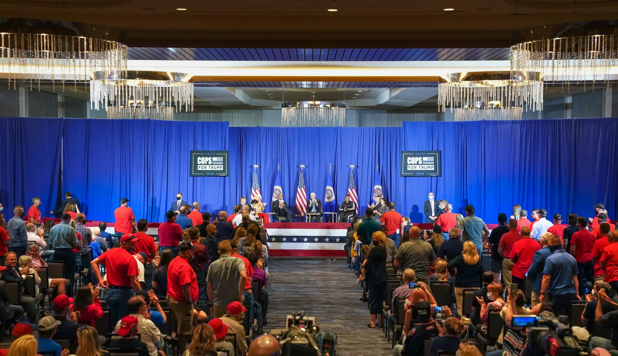 Vice President Mike Pence invited all the police officers in the audience to stand and be recognized with applause. Vice President Mike Pence and Ivanka Trump are holding a 'Cops for Trump' listening session in Minneapolis, meeting with community members whose businesses and lives have been negatively impacted by crime and rioting.