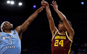 Gophers guard Cam Christie (24) puts up a jump shot over Indiana State's Ryan Conwell (3) during the second round of the NIT on Sunday in Terre Haute