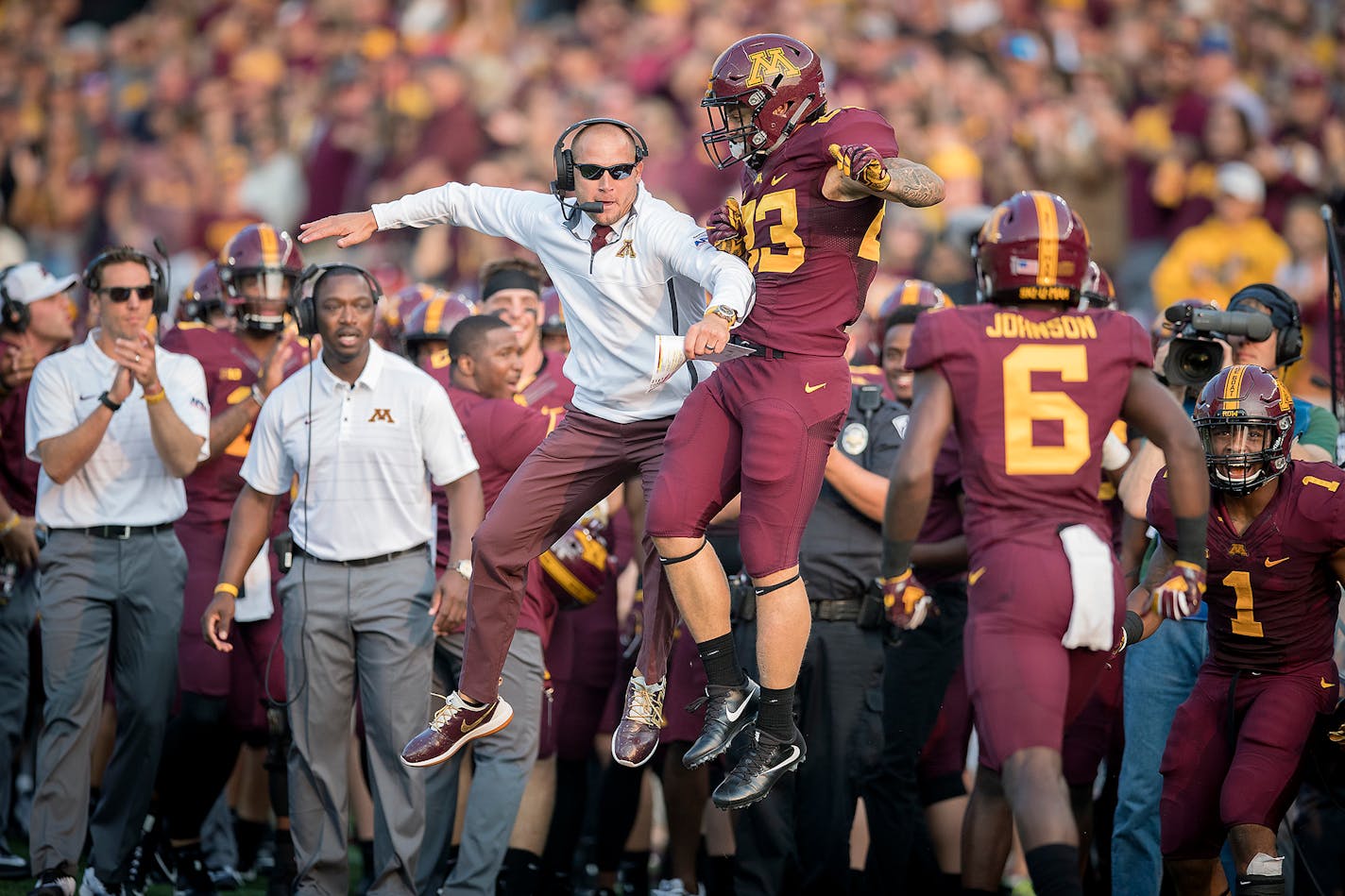 Minnesota coach P.J. Fleck celebrates a first-quarter touchdown with running back Shannon Brooks