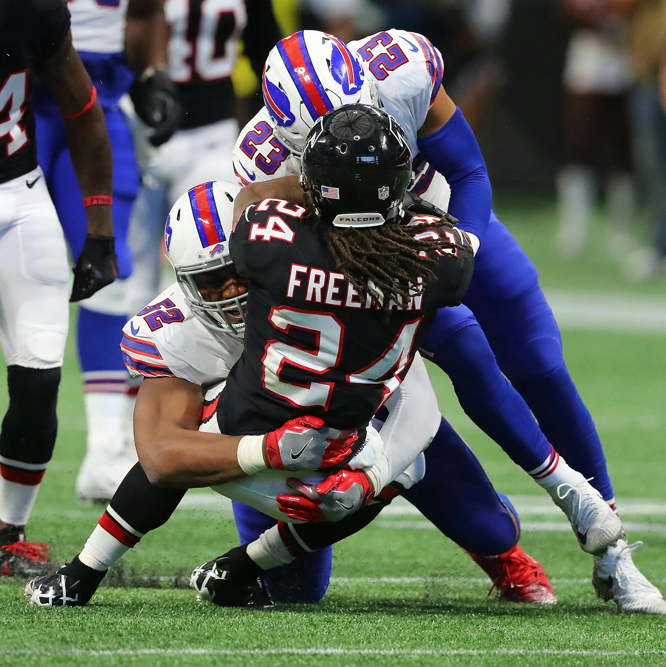 Buffalo Bills defenders Preston Brown and Micah Hyde tackle Atlanta Falcons running back Devonta Freeman during the second half on Sunday, Oct. 1, 2017, in Atlanta, Ga. The Bills defeated the Falcons 23-17. (Curtis Compton/Atlanta Journal-Constitution/TNS)