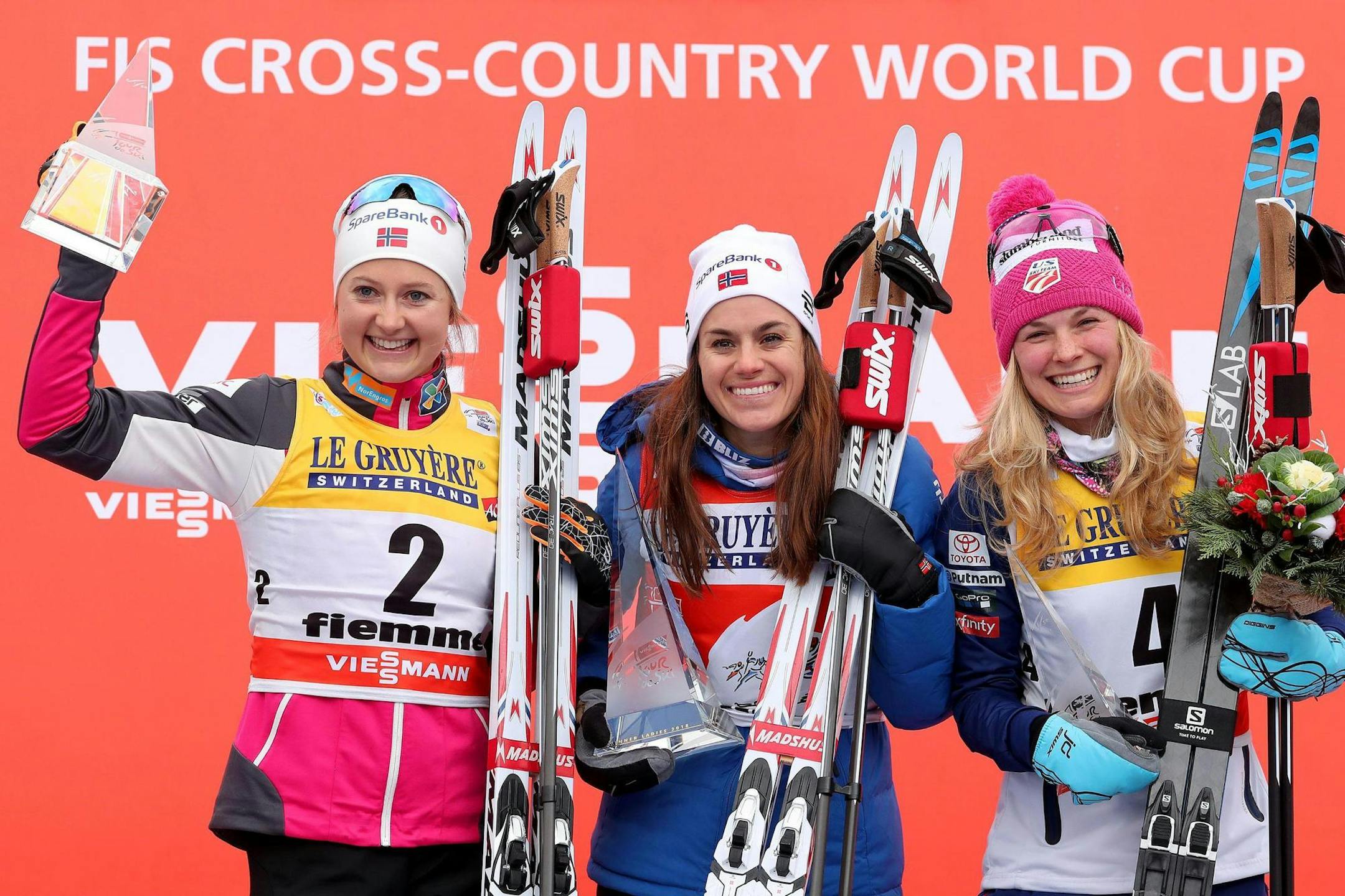 Heidi Weng of Norway, winner of a cross-country ski women's 9 km Final Climb Pursuit race Sunday, celebrated on the podium with second-place Ingvild Flugstad Oestberg of Norway, left, and third-place Jessie Diggins of Afton, Minn., at the FIS Tour de Ski event in Val di Fiemme, Italy.