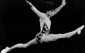August 3, 1984 Los Angeles: Like a star-spangled bird in flight, soaring high above the balance beam 8/3, Mary Lou Retton wins the gold medal in gymna