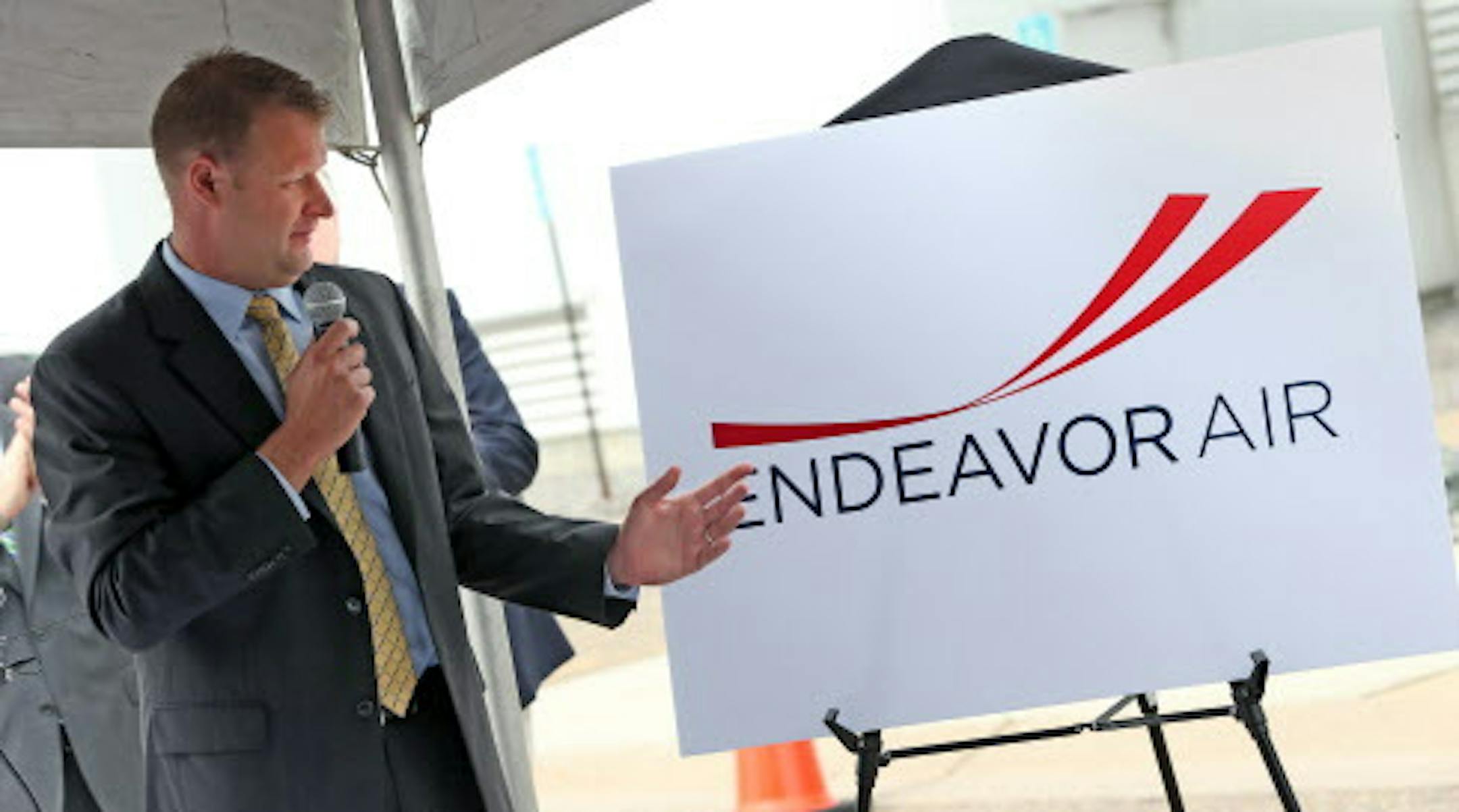 Ryan Gumm, President & CEO of Endeavor Air showed off the new company logo, during the ribbon cutting ceremonies at the Endeavor Air headquarters, formerly Pinnacle Airlines, at the Minneapolis St. Paul Airport on 6/26/13.] Bruce Bisping/Star Tribune bbisping@startribune.com