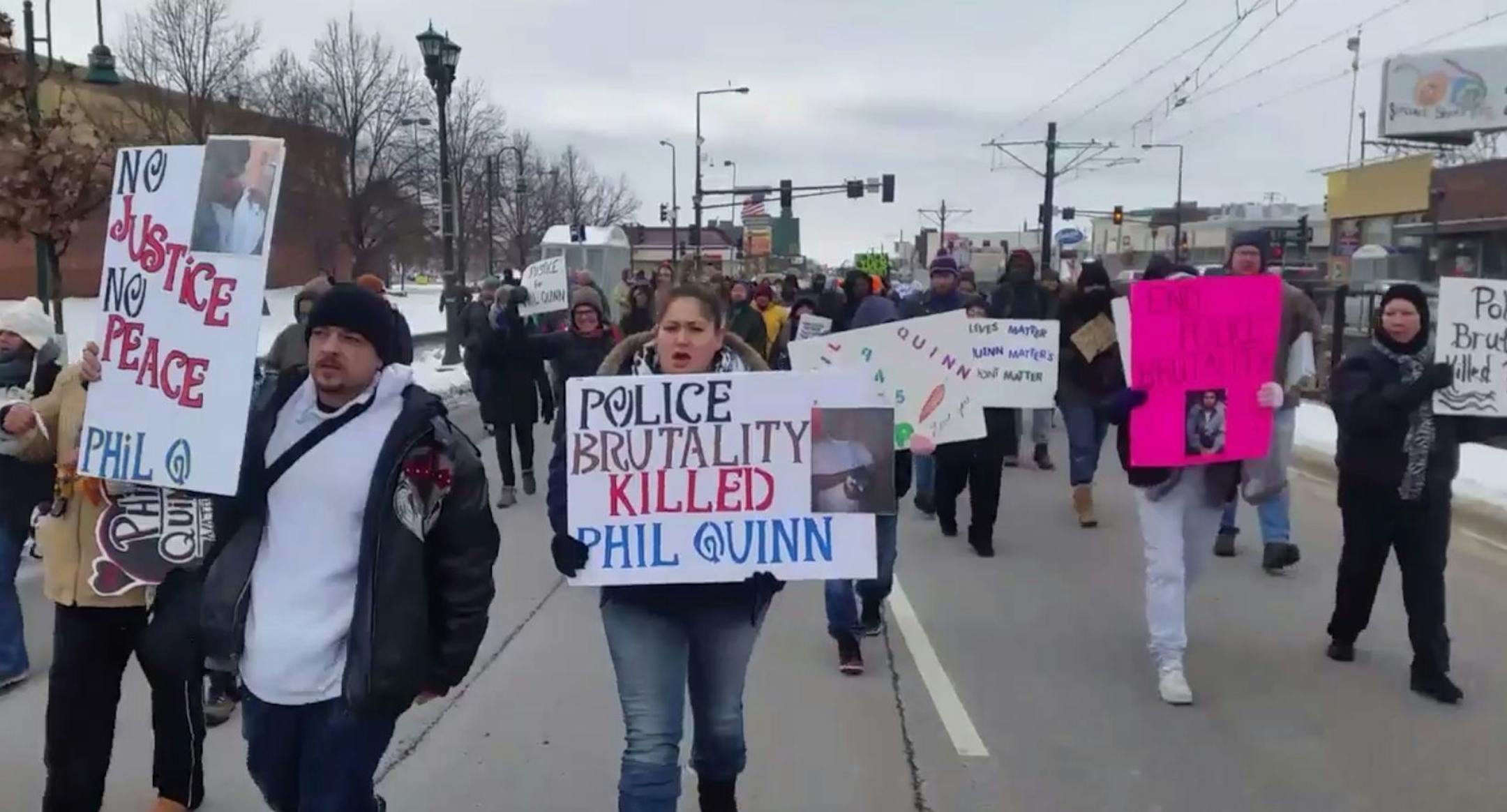 Protesters march down University Avenue in St. Paul on Saturday to protest the police shooting of Phil Quinn.