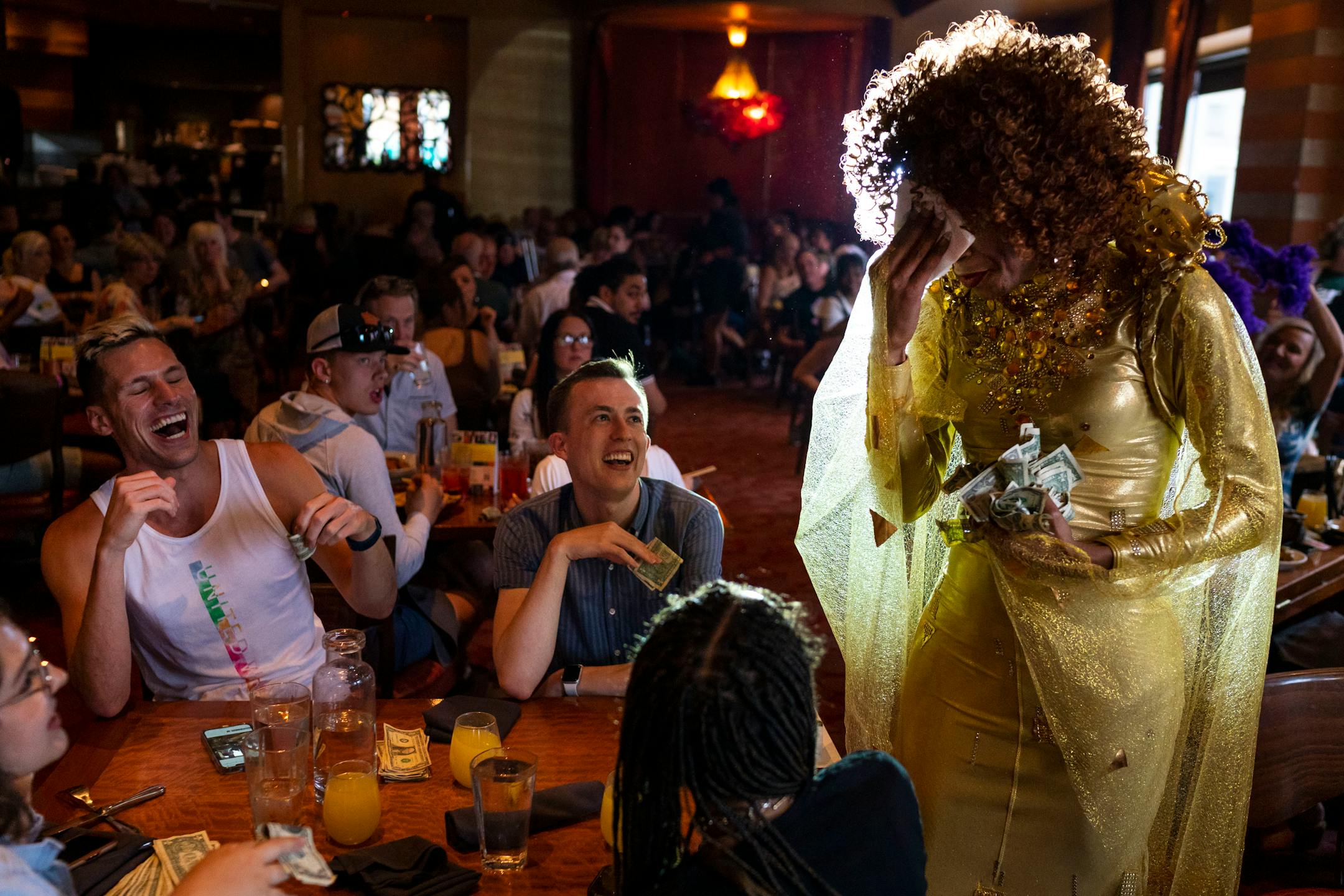 Cee Cee Russell, right, takes a napkin from a table to wipe off during his performance at Crave on Sunday, June 20, 2021, in Minneapolis. ] ANTRANIK TAVITIAN • anto.tavitian@startribune.com