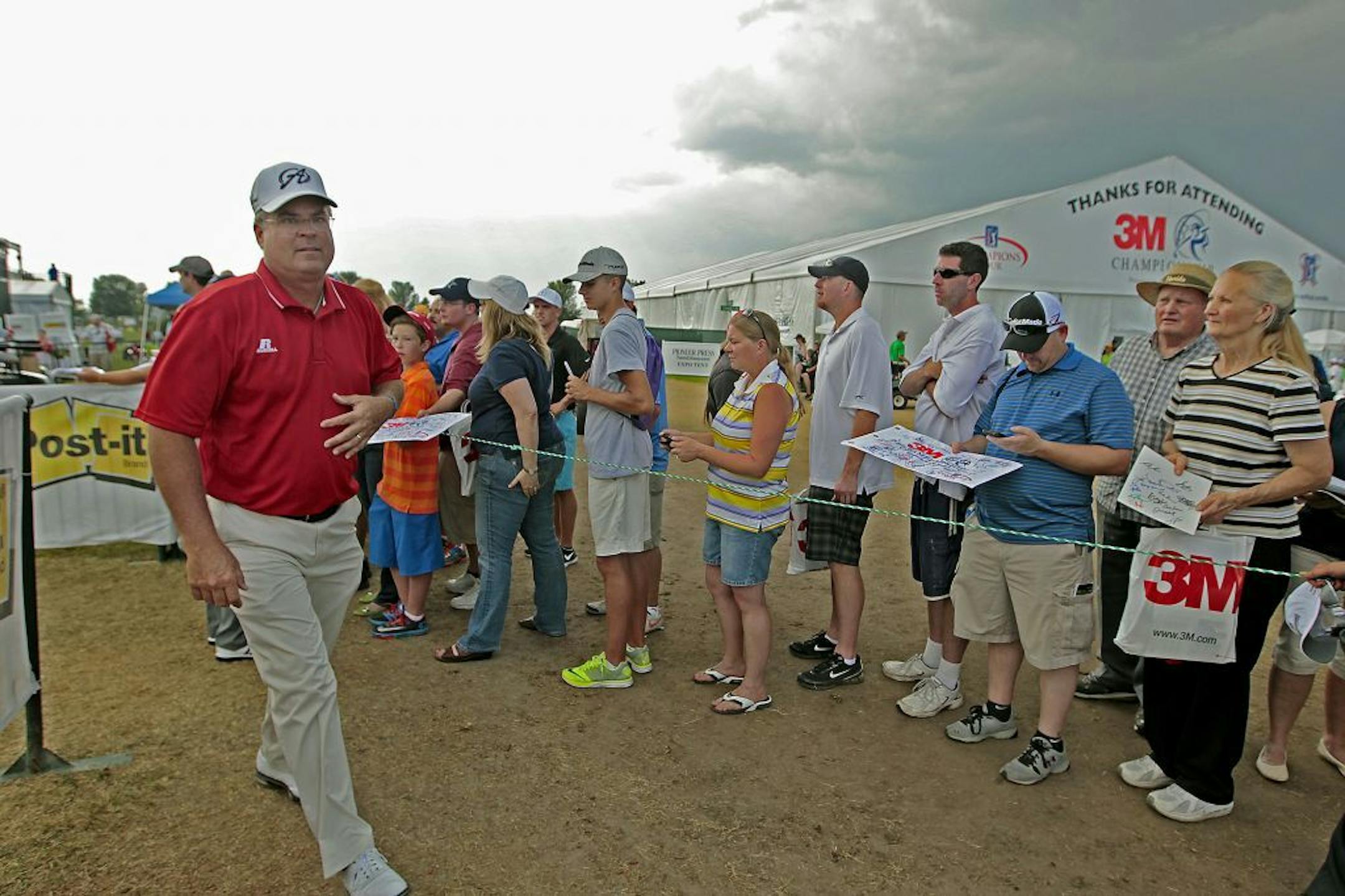 Kenny Perry made his way off the grounds as a storm loomed in the background delaying play on the 18th hole during the second round of the 3M Championships, Saturday, August 2, 2014 in Blaine, MN.