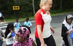Counselor Crystal Altobelli, holding the hand of Zagal Abdi,7, helped kids cross the street from a nearby park.