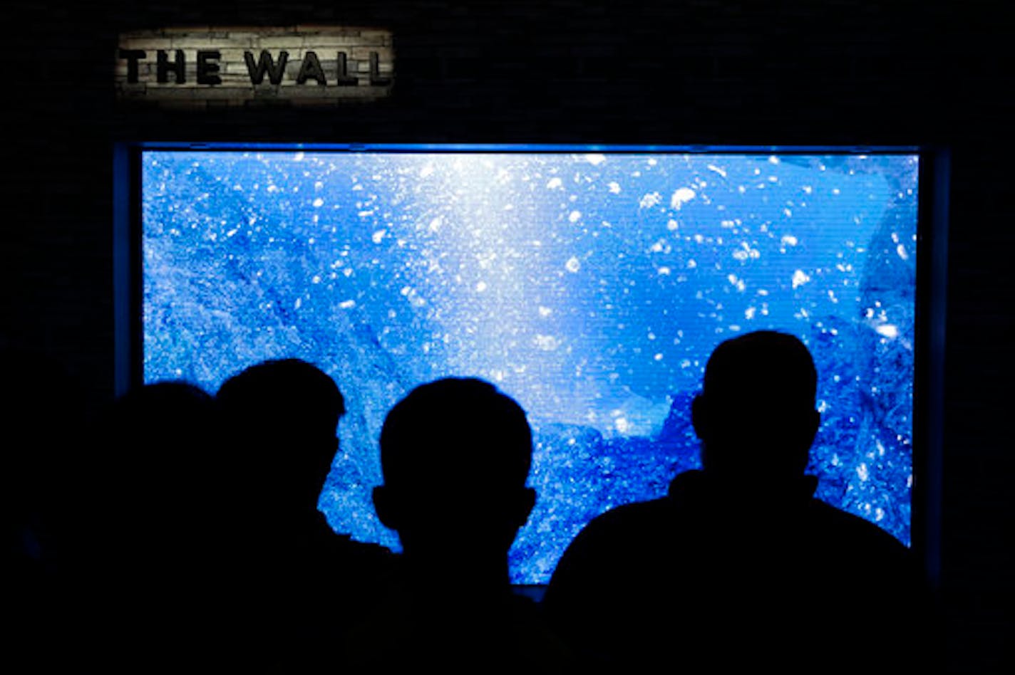 Attendees look at Samsung's "The Wall" modular television at CES International Wednesday, Jan. 10, 2018, in Las Vegas. (AP Photo/Jae C. Hong)