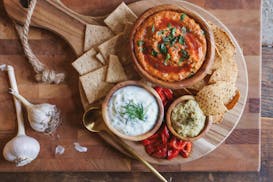 A trio of dips — Red Pepper-Hazelnut Spread, hummus and Fennel, Cucumber and Yogurt Dip (Tzatziki) make a great holiday party spread and accompanime