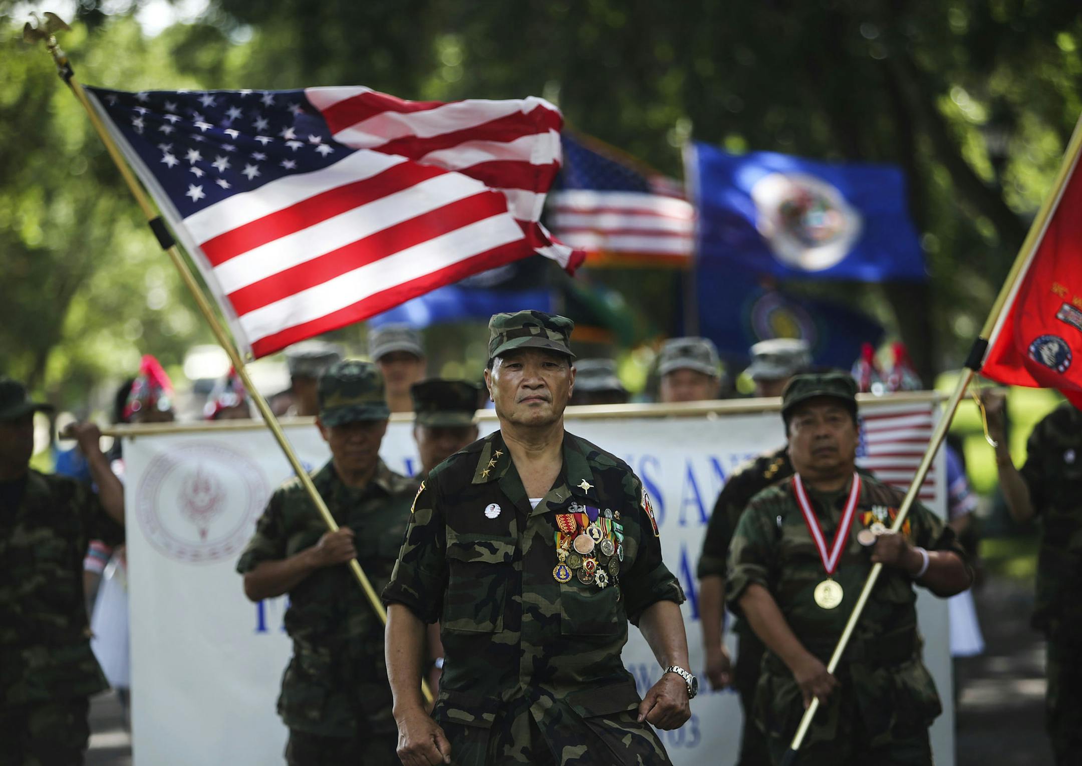 As part of Lao-Hmong Recognition Day on Tuesday, which honors Lao-Hmong American veterans, members of St. Paul's Hmong community paraded from the Hayden Heights Recreation Center to the General Vang Pao Community Center. Capt. Xiong Yia led the parade.