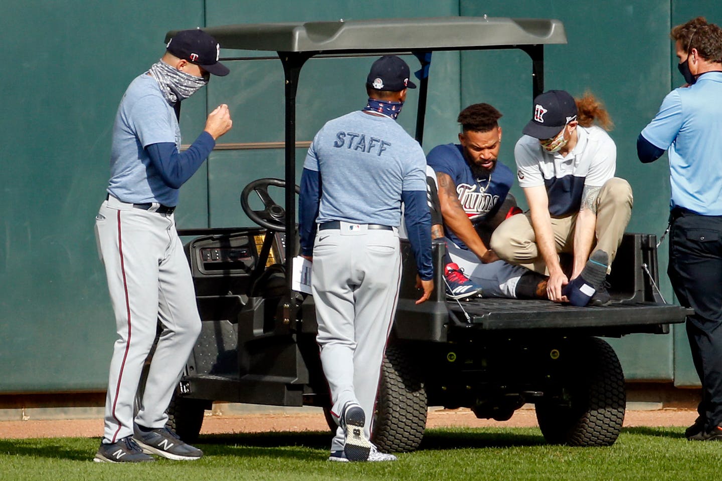 (From left) Twins manager Rocco Baldelli and coach Tony Diaz watched as assistant athletic trainer Matt Biancuzzo steadied the ankle of center fielder Byron Buxton, who was injured in an intrasquad game at Target Field on Monday and was taken off on a cart.