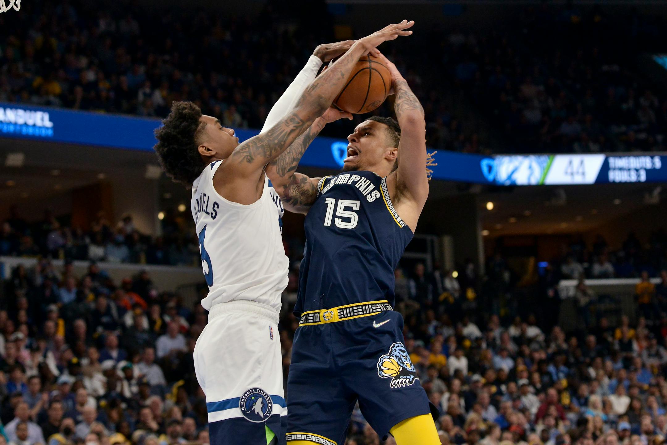 Memphis Grizzlies forward Brandon Clarke (15) shoots against Minnesota Timberwolves forward Jaden McDaniels (3) during the first half during Game 2 of a first-round NBA basketball playoff series Tuesday, April 19, 2022, in Memphis, Tenn. (AP Photo/Brandon Dill)