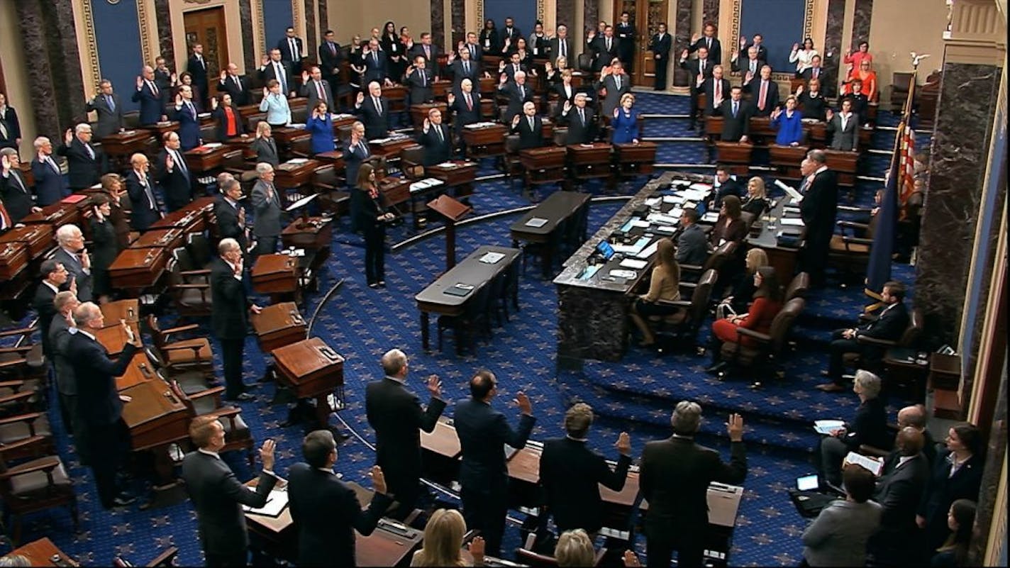 In this Jan. 16, 2020, image from video, presiding officer Supreme Court Chief Justice John Roberts swears in members of the Senate for the impeachment trial against President Donald Trump at the U.S. Capitol in Washington.