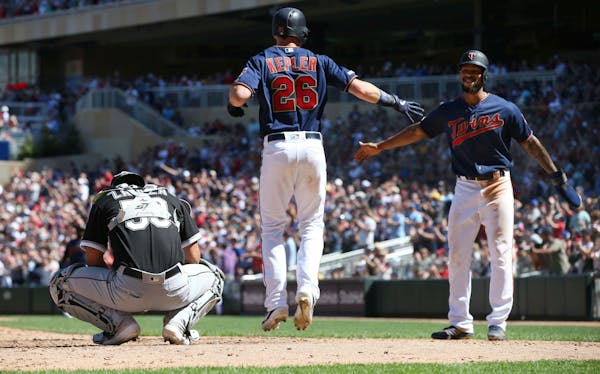 The Twins' Max Kepler jumped for joy and greeted Martin Gonzalez, right, after Kepler's three-run homer off White Sox pitcher Josh Osich in the sevent