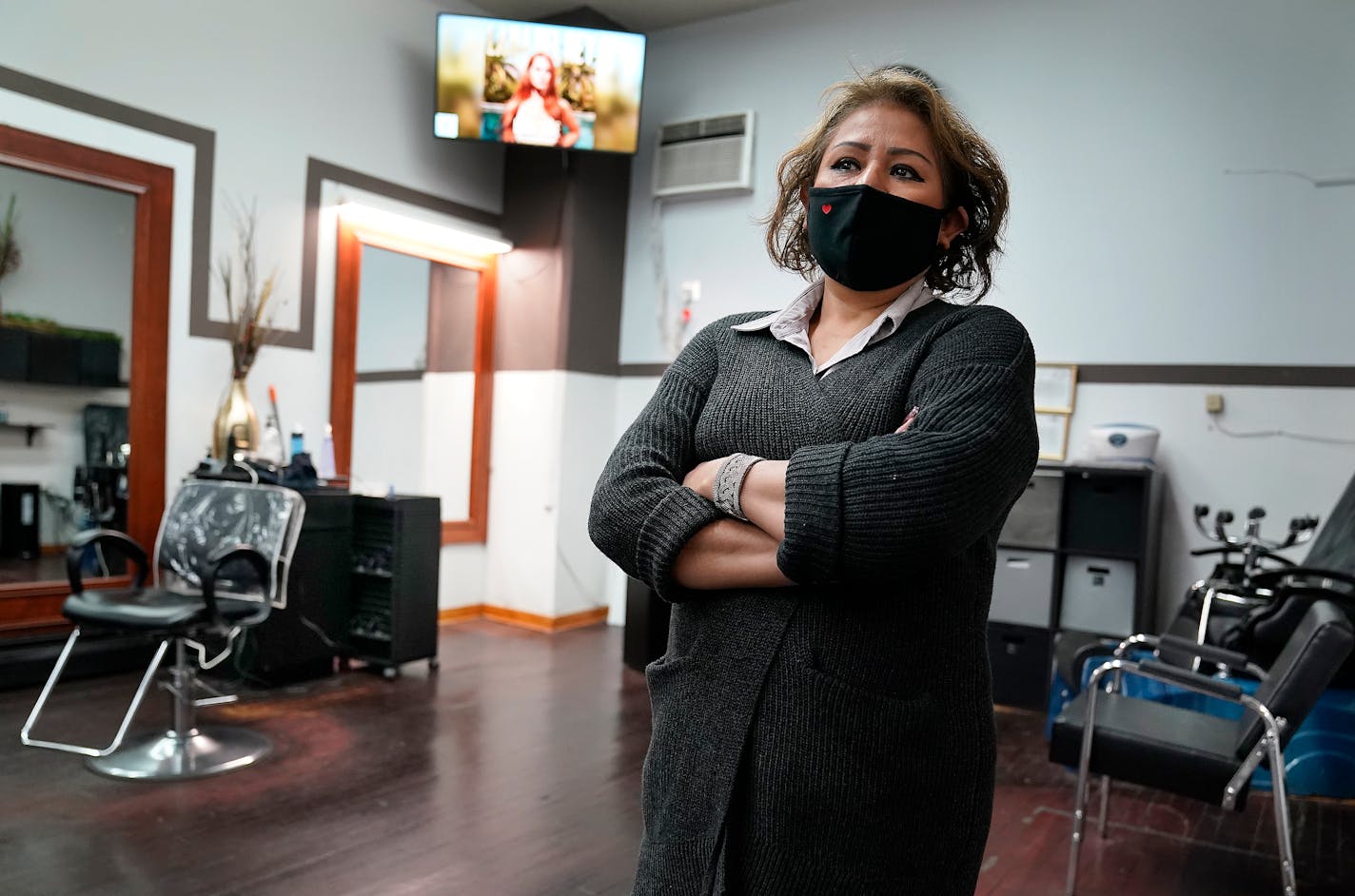 Gloria Morales, who owns and operates Gloria's Beauty Salon, at her mostly empty salon in Minneapolis.