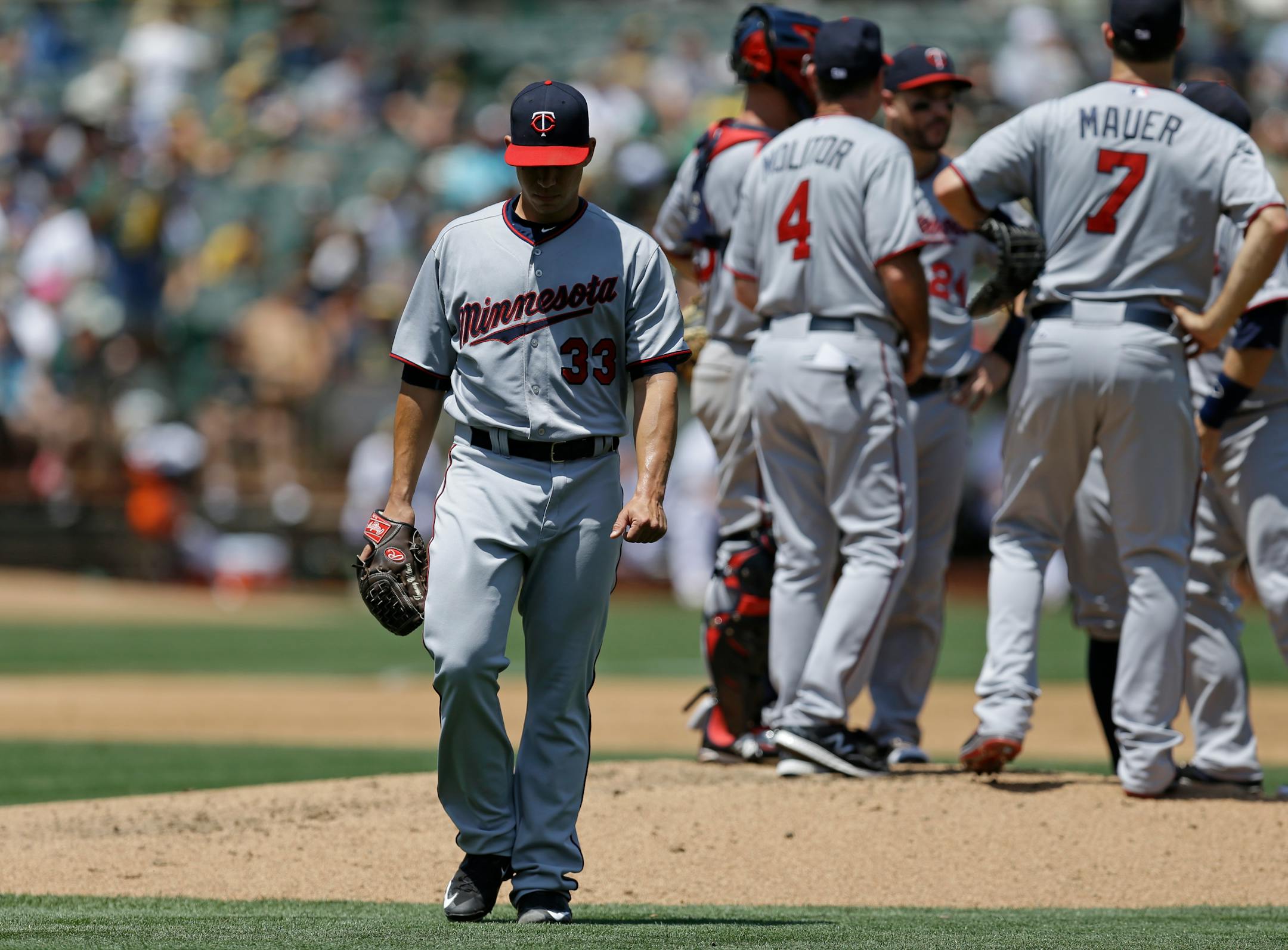 Twins starter Tommy Milone walked off the field after being removed in the third inning of the Athletics' 14-1 rout of the Twins on Sunday in Oakland.