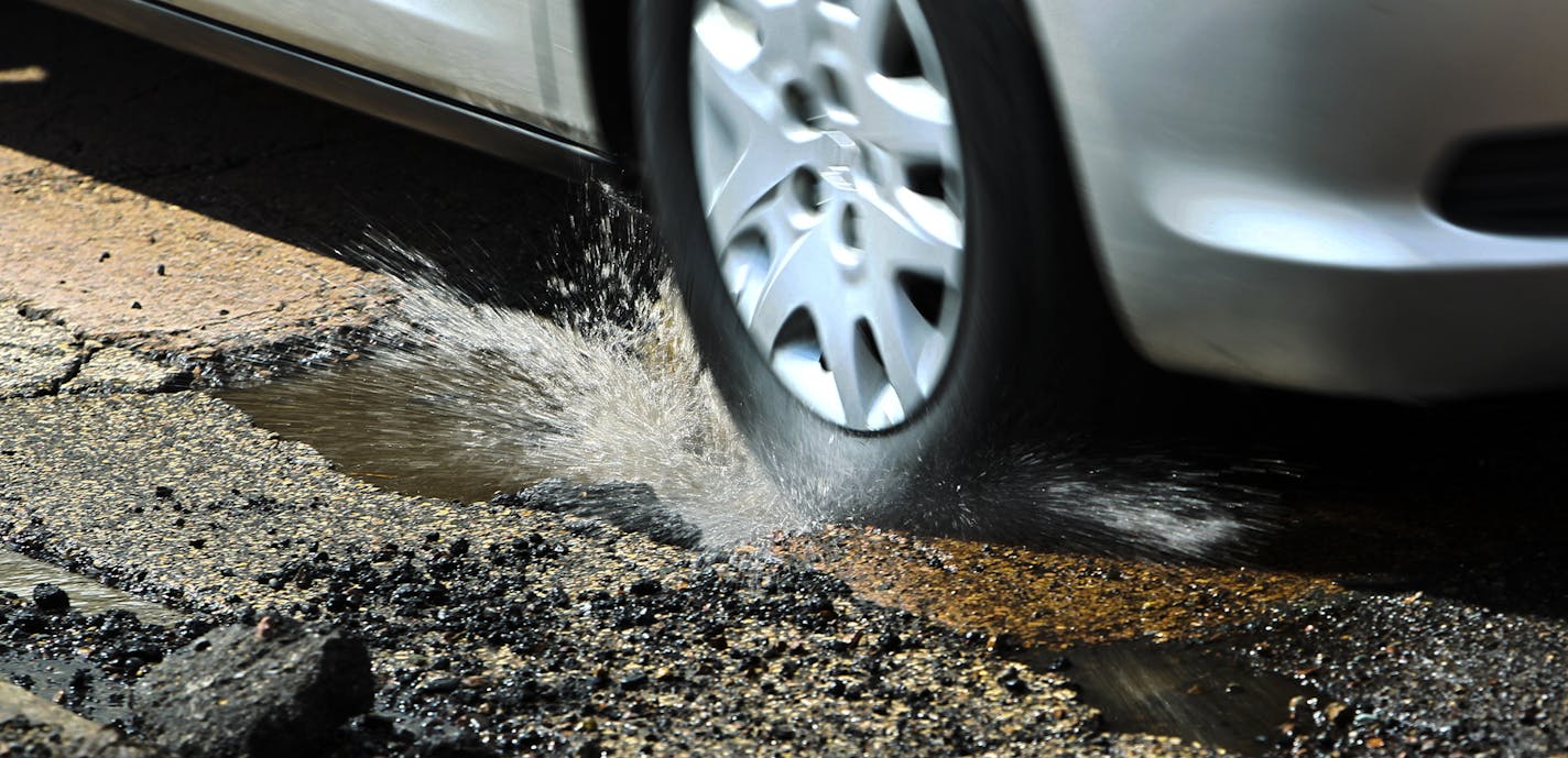 Cars driving on E. Minnehaha Parkway along Lake Nokomis tried to dodge potholes in the roadway in Minneapolis in 2013.