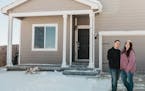 Army Staff Sgt. Shaun Horton and his wife, Kassi, in front of their new first home in Colorado Springs, bought online. A change in assignment for Sgt.