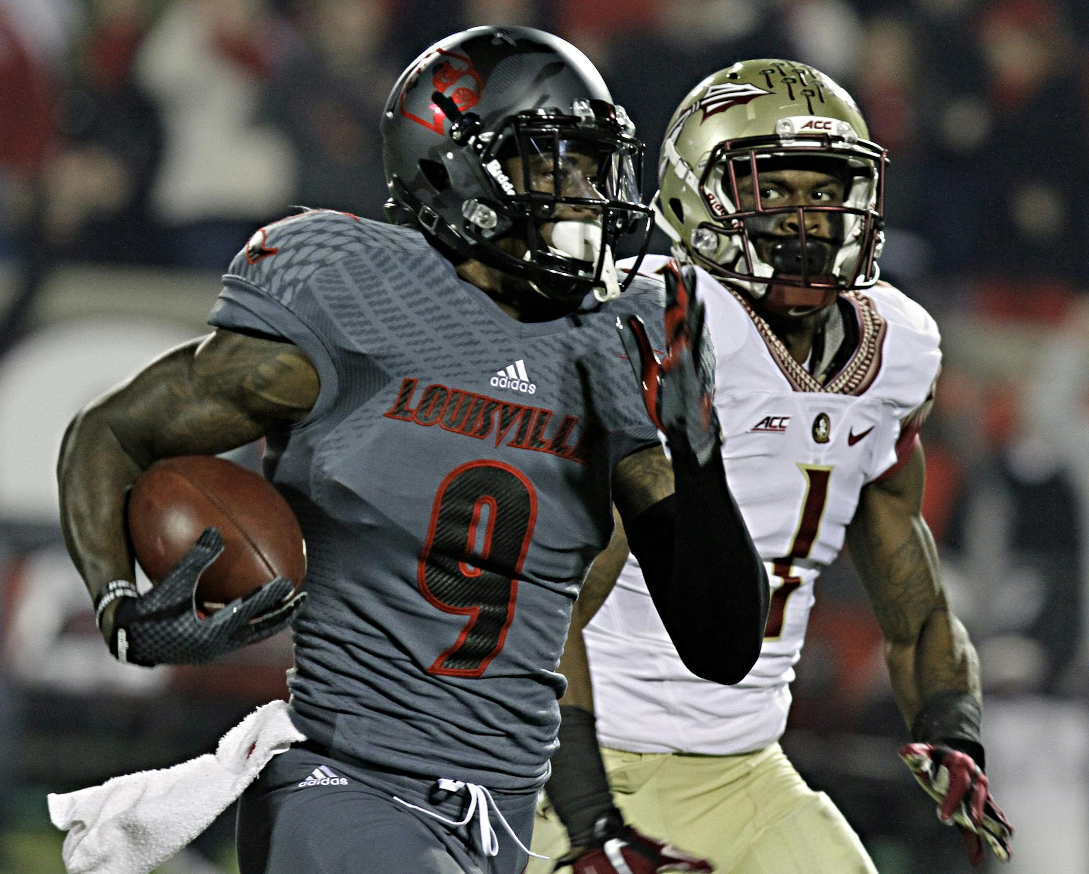 Louisville wide receiver DeVante Parker (9) outruns Florida State defensive back Tyler Hunter (1) on a long pass reception in the first half of their NCAA college football game in Louisville, Ky., Thursday, Oct. 30, 2014. (AP Photo/Garry Jones) ORG XMIT: KYUL112
