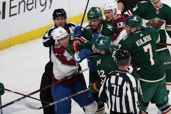 Colorado Avalanche right wing Logan O'Connor (25) and Minnesota Wild left wing Kevin Fiala (22) shove each other during the third period of an NHL hoc