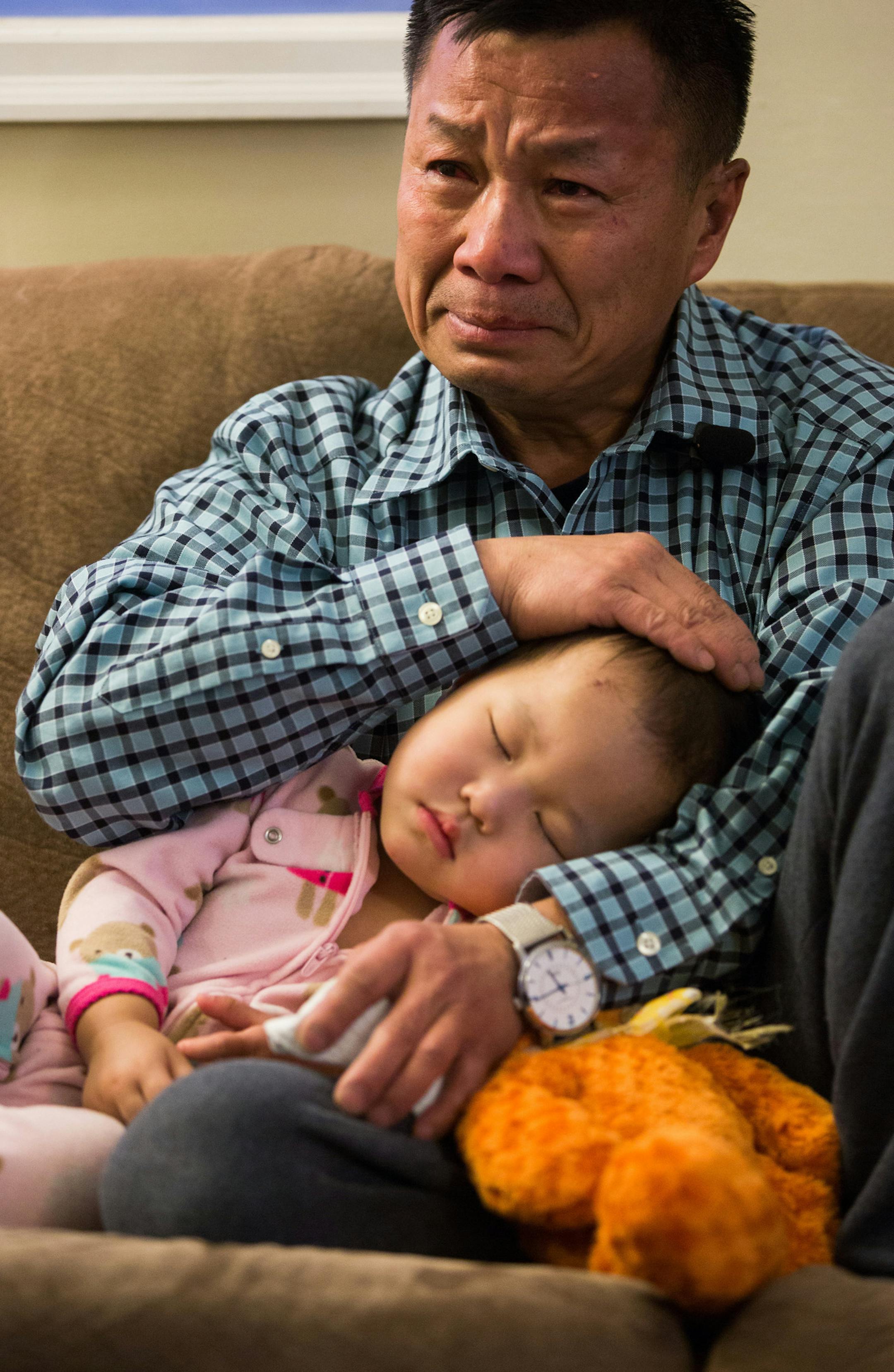 Peter Yang held his 18-month-old daughter Sanjana Yang as he recalled searching though choking smoke for her four-year-old sister Ntshialiag during a fire at their house Sunday night. ] Mark Vancleave - mark.vancleave@startribune.com * Peter “Dao” Yang gathered with relatives at a son's house in St. Paul on Tuesday, Feb. 10, 2015.