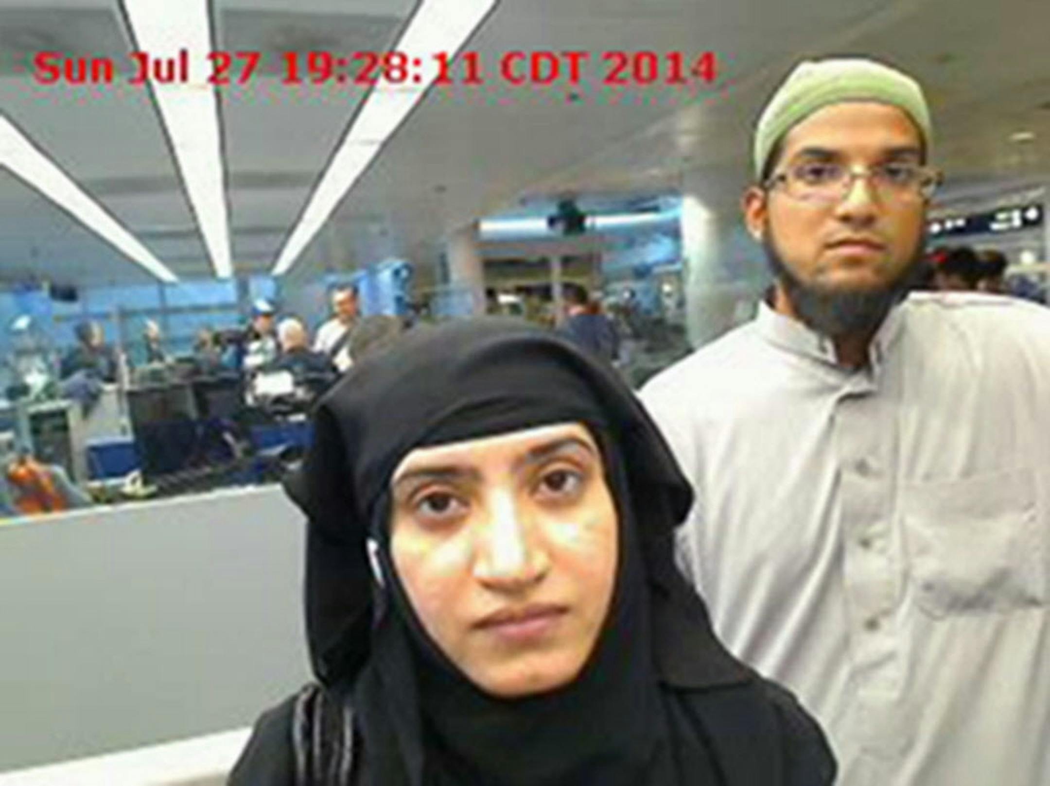 This July 27, 2014, file photo shows Tashfeen Malik, left, and Syed Farook, as they passed through O'Hare International Airport in Chicago. The husband and wife died on Dec. 2, 2015, in a gun battle with authorities several hours after their assault on a gathering of Farook's colleagues in San Bernardino, Calif.