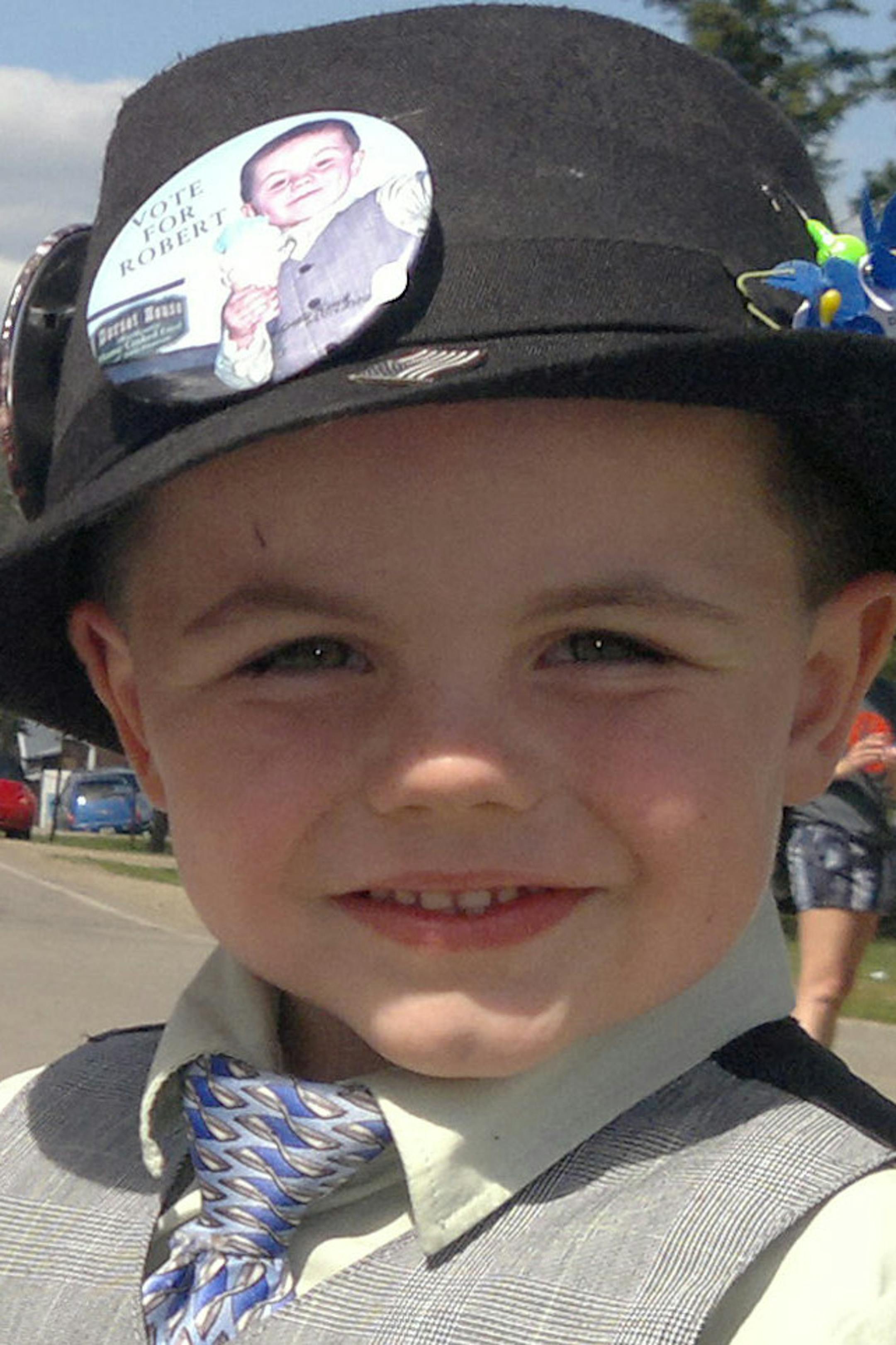 FILE - This handout file photo provided by the Tufts family shows Mayor Robert "Bobby" Tufts, right, shaking hands with a supporter in the tiny tourist town of Dorset, Minn. Tufts lost his bid for a third consecutive term as mayor of Dorset on Sunday, Aug. 4, 2014. (AP Photo/Courtesy Tufts Family, File) ORG XMIT: MIN2014080822403081