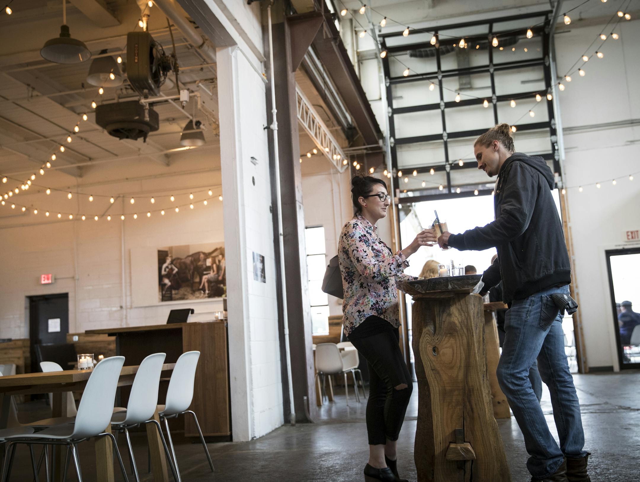 Dawn O'Connell and John Eidem toasted their drinks (a Queen Park Sizzle and a Premiere) at Norseman Distillery in Minneapolis.