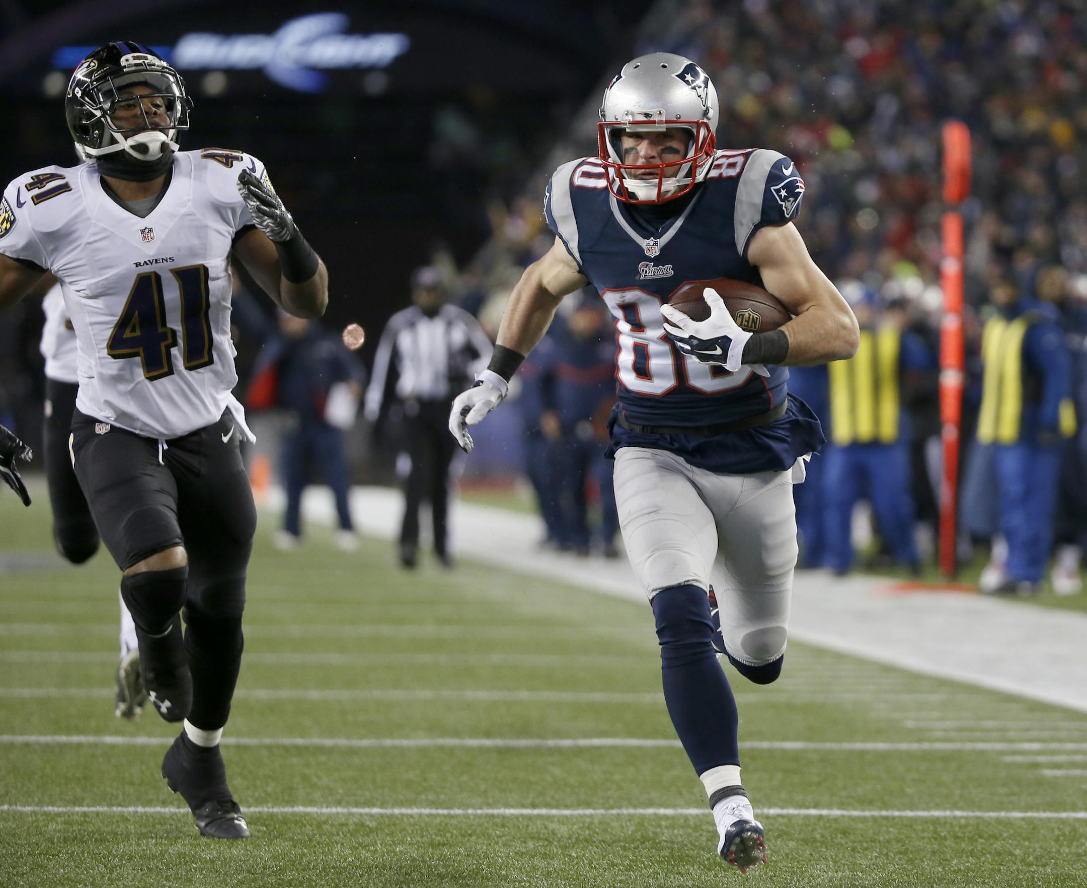 New England Patriots wide receiver Danny Amendola (80) runs with a touchdown pass from Julian Edelman, as he runs from Baltimore Ravens defensive back Rashaan Melvin (38) in the second half of an NFL divisional playoff football game Saturday, Jan. 10, 2015, in Foxborough, Mass. (AP Photo/Elise Amendola)