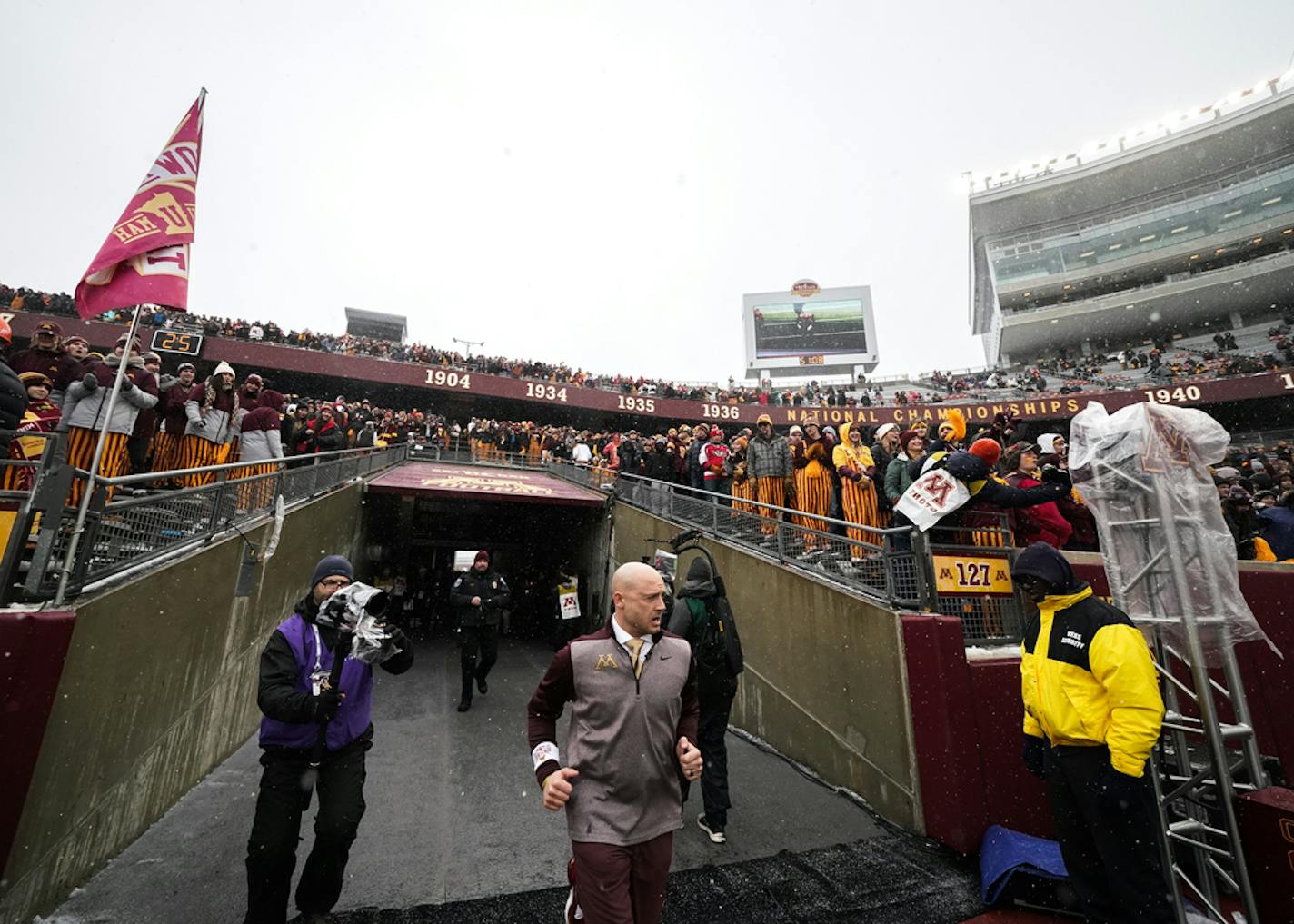 Minnesota Gophers head coach PJ Fleck takes the field before a game.